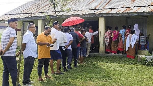 <div class="paragraphs"><p>Voters wait in a queue at a polling station to cast their votes for the first phase of Lok Sabha&nbsp;elections,&nbsp;in Manipur,&nbsp;Friday, April 19, 2024.</p></div>