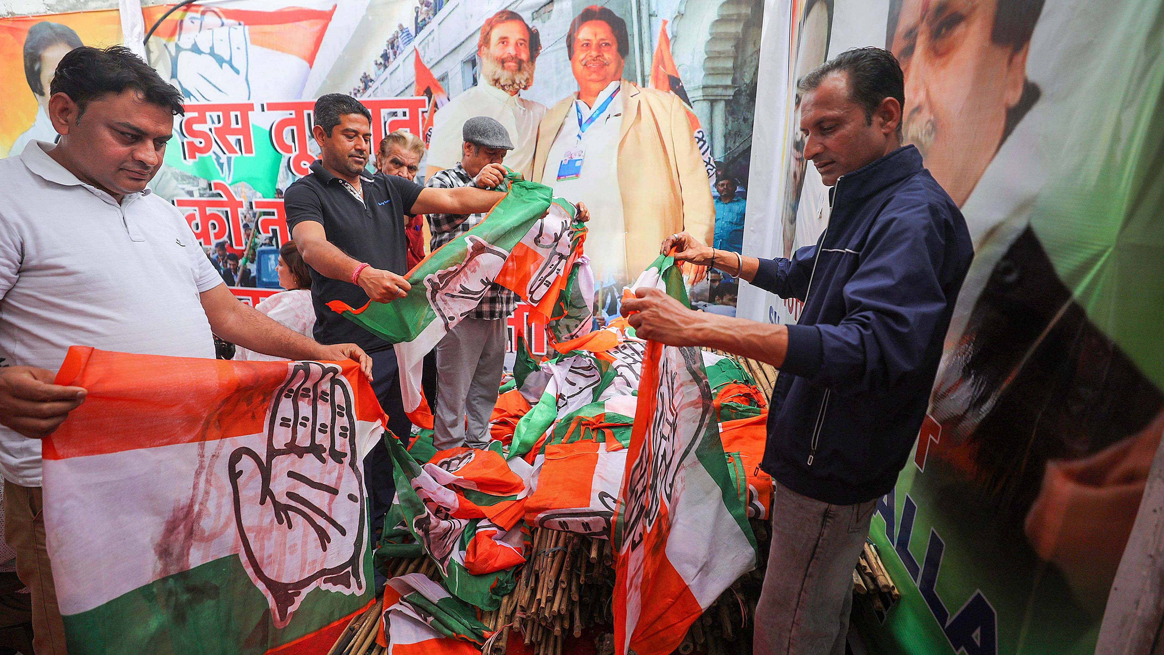 <div class="paragraphs"><p>Workers arrange Congress party flags ahead of Lok Sabha elections, in Jammu, Friday, March 29, 2024. </p></div>