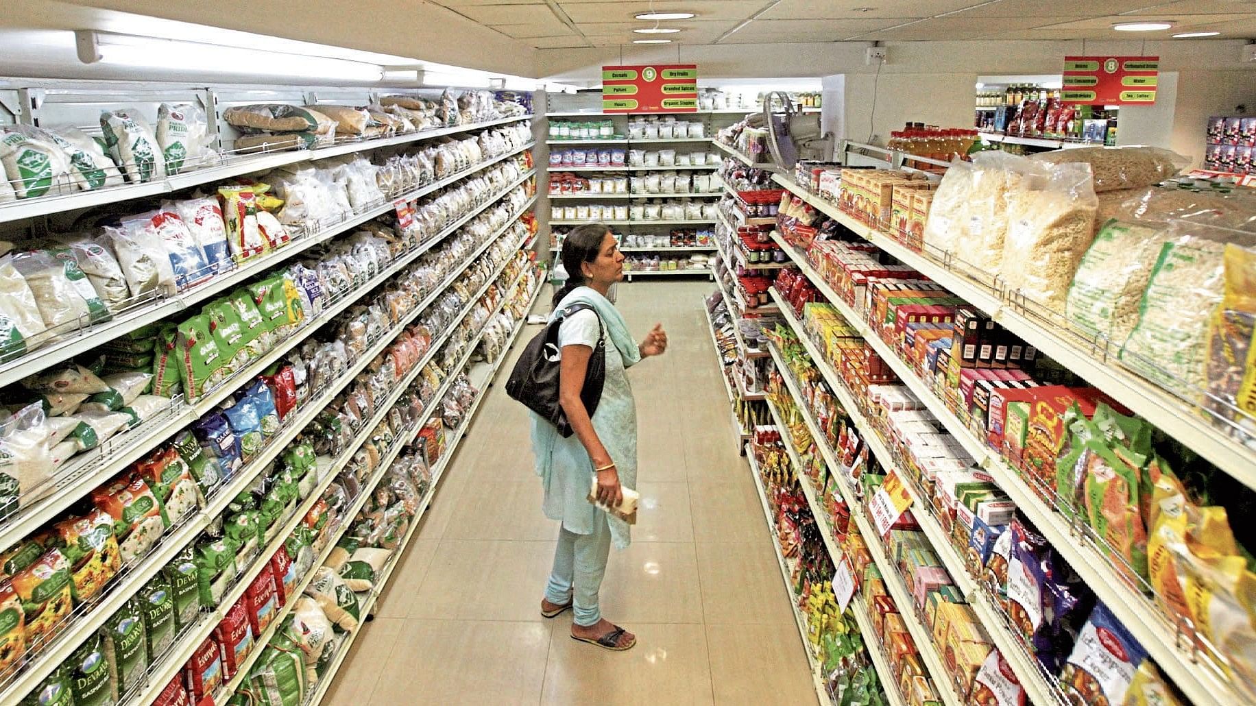 <div class="paragraphs"><p>A customer looks at consumable goods before buying them at a supermarket in the southern Indian city of Hyderabad.</p></div>