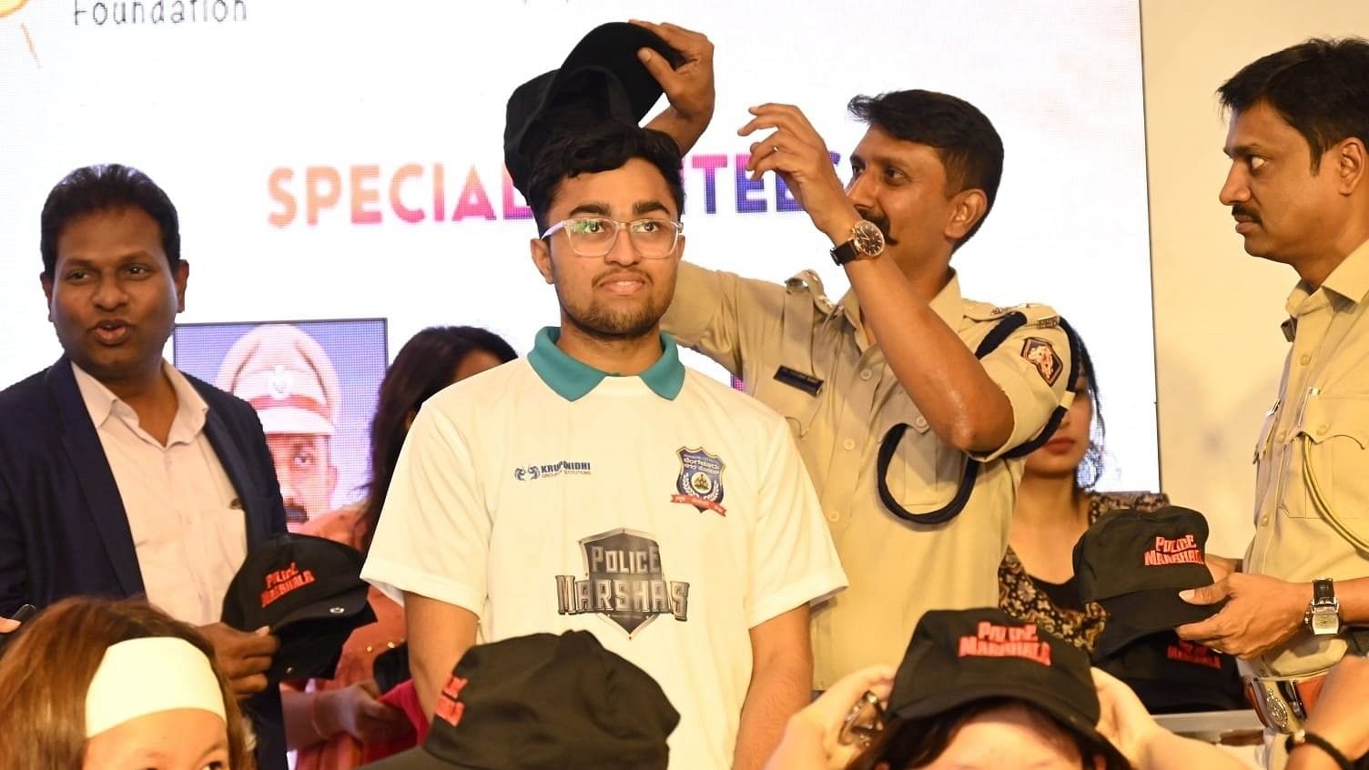 <div class="paragraphs"><p>A cop inducts a Student Police Marshal in Bengaluru.</p></div>