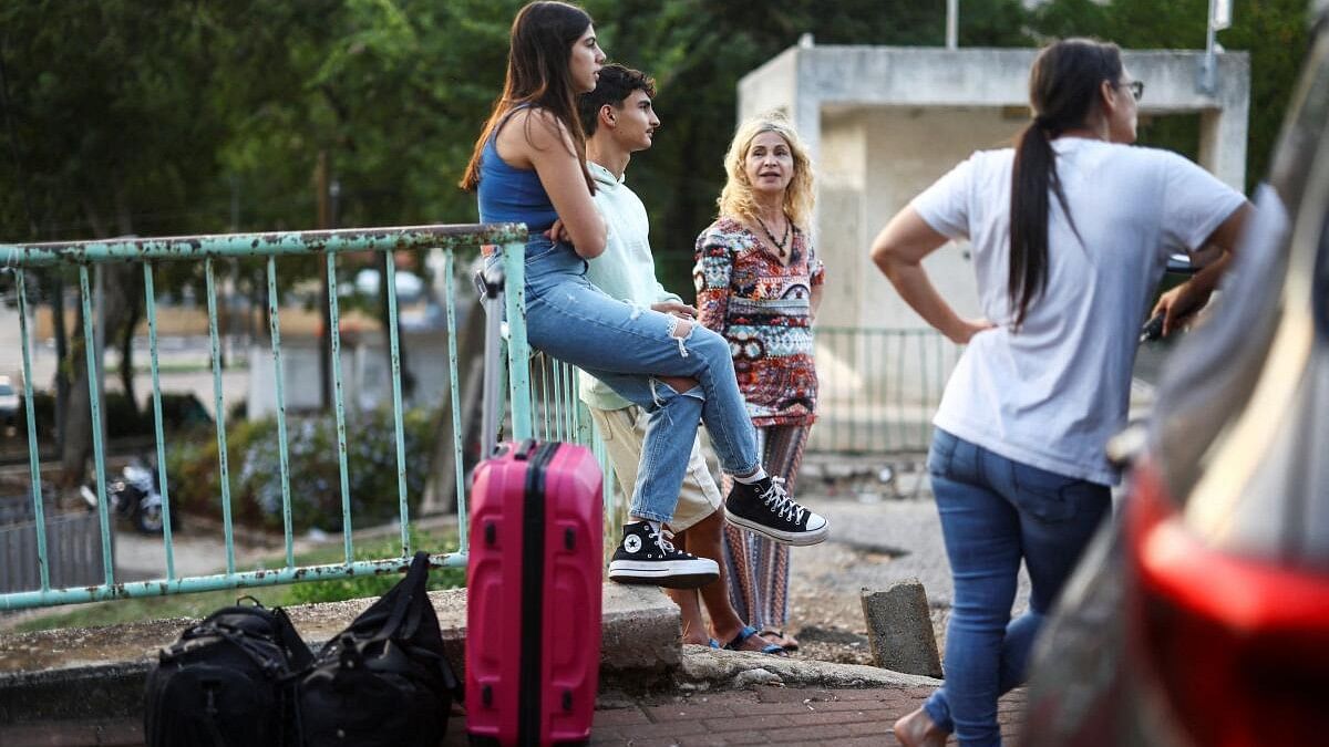 <div class="paragraphs"><p>Israelis wait with their bags before being evacuated from Kiryat Shmona, near Israel's border with Lebanon, in northern Israel.</p></div>