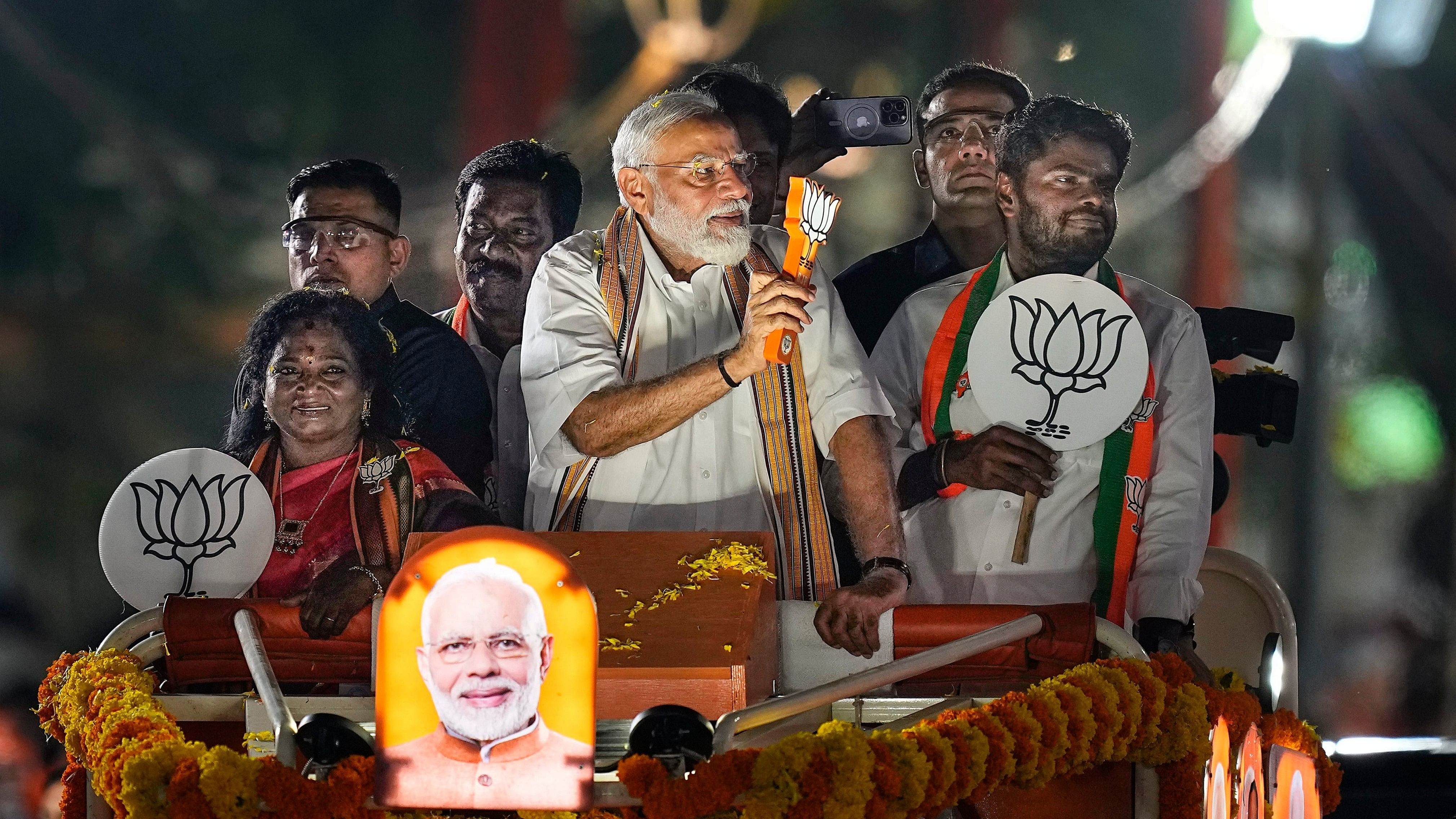 <div class="paragraphs"><p>Prime Minister Narendra Modi greets supporters during a roadshow in support of BJP's candidate from South Chennai constituency Tamilisai Soundararajan, ahead of the Lok Sabha election, in Chennai, Tuesday, April 9, 2024. </p></div>