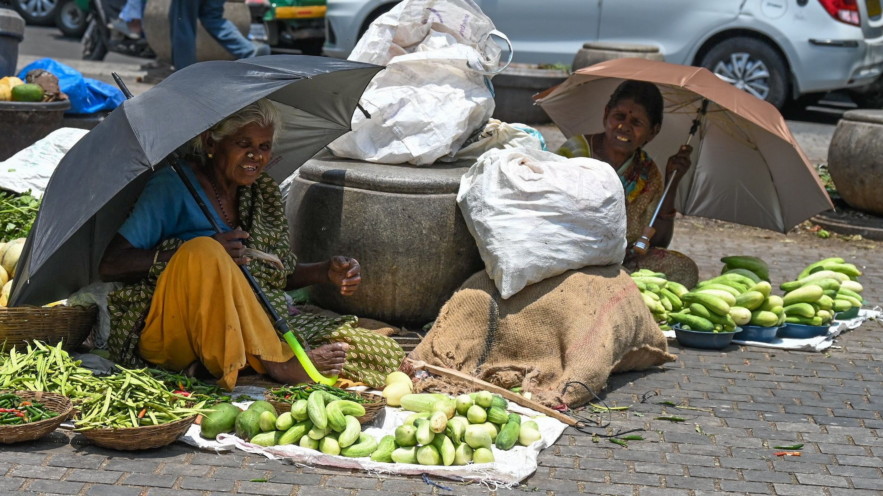 <div class="paragraphs"><p>Vendors use umbrellas to shield themselves from the scorching heat at Kalasipalyam.</p></div>
