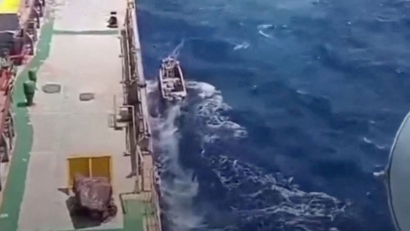 <div class="paragraphs"><p>A boat sails next to a shipping vessel MV Abdullah in this screengrab obtained from a social media video released on March 12, 2024. </p></div>