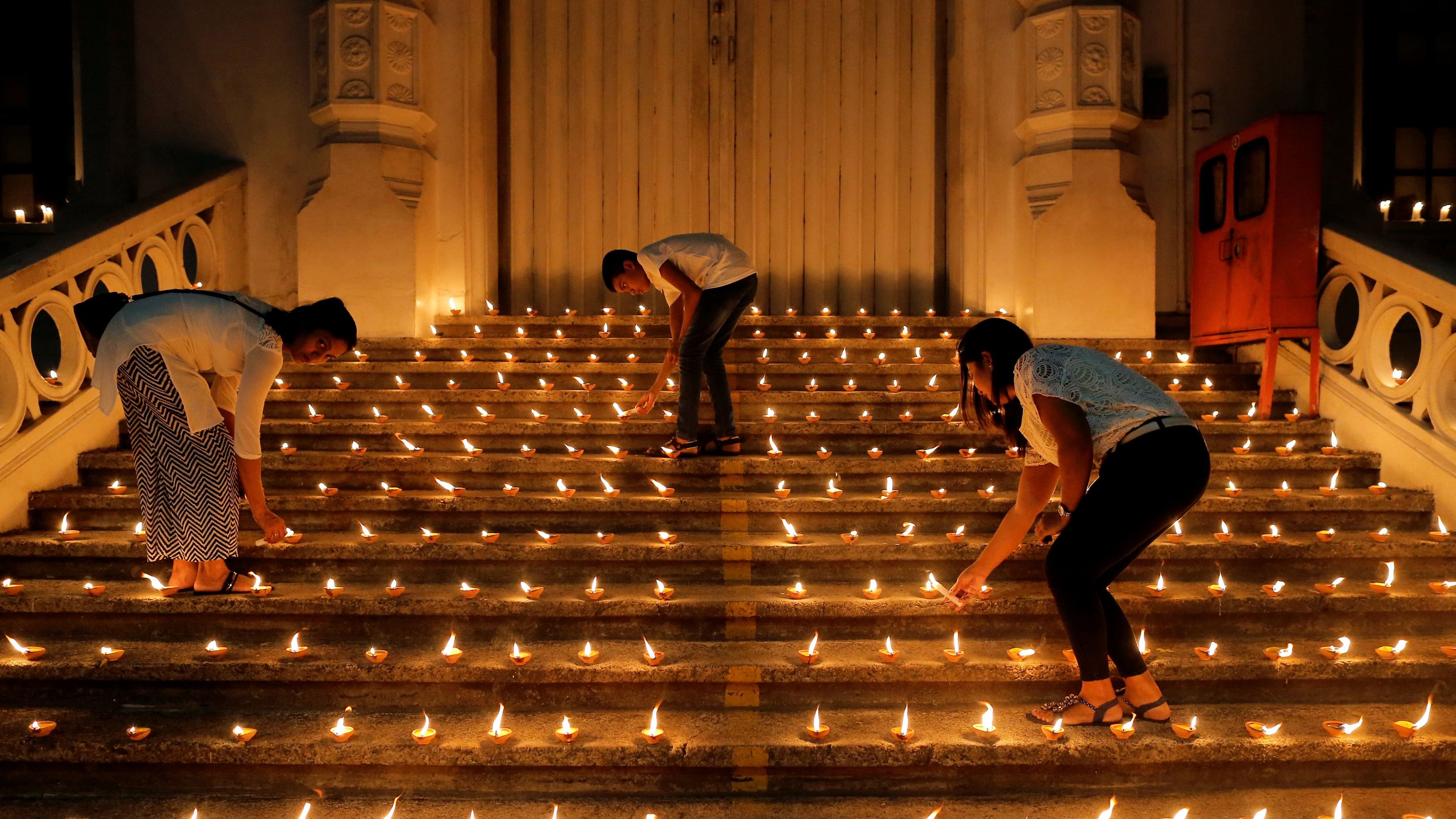 <div class="paragraphs"><p>File photo of people lighting candles during a vigil in memory of the victims of a string of suicide bomb attacks across the island on Easter Sunday, in Colombo, Sri Lanka onApril 28, 2019.</p></div>