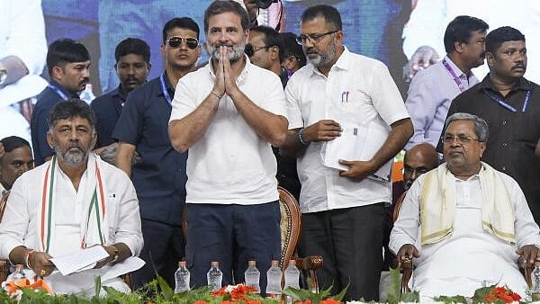 <div class="paragraphs"><p>Congress leader Rahul Gandhi with Karnataka Chief Minister Siddaramaiah and Deputy Chief Minister DK Shivakumar during a public meeting ahead of the Lok Sabha elections, in Mandya district, Wednesday, April 17, 2024. </p></div>