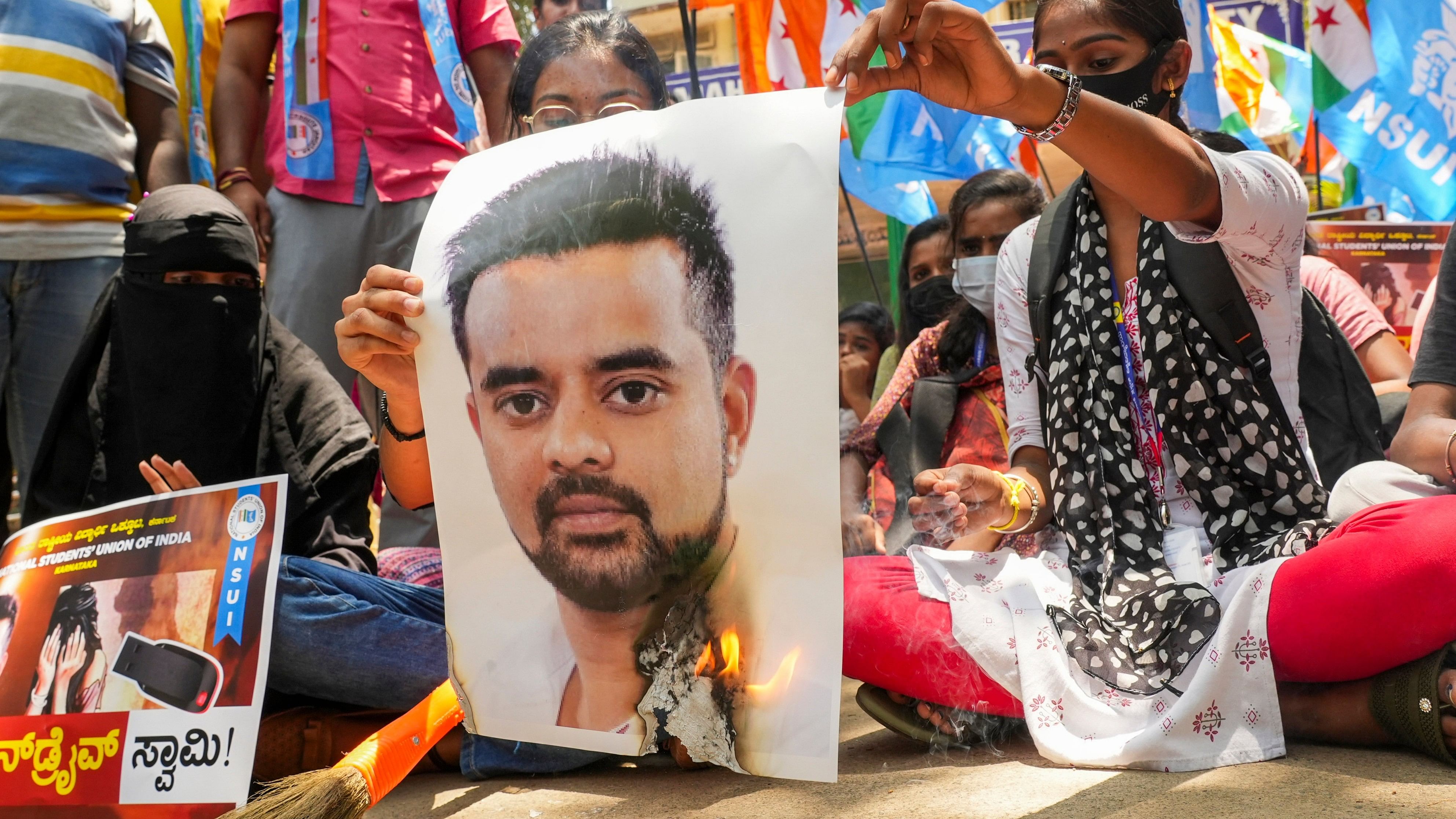 <div class="paragraphs"><p>NSUI members burn a poster of JD(S) MP Prajwal Revanna during a protest against his involvement in the alleged sexual abuse case, in Bengaluru, Tuesday, April 30, 2024. </p></div>