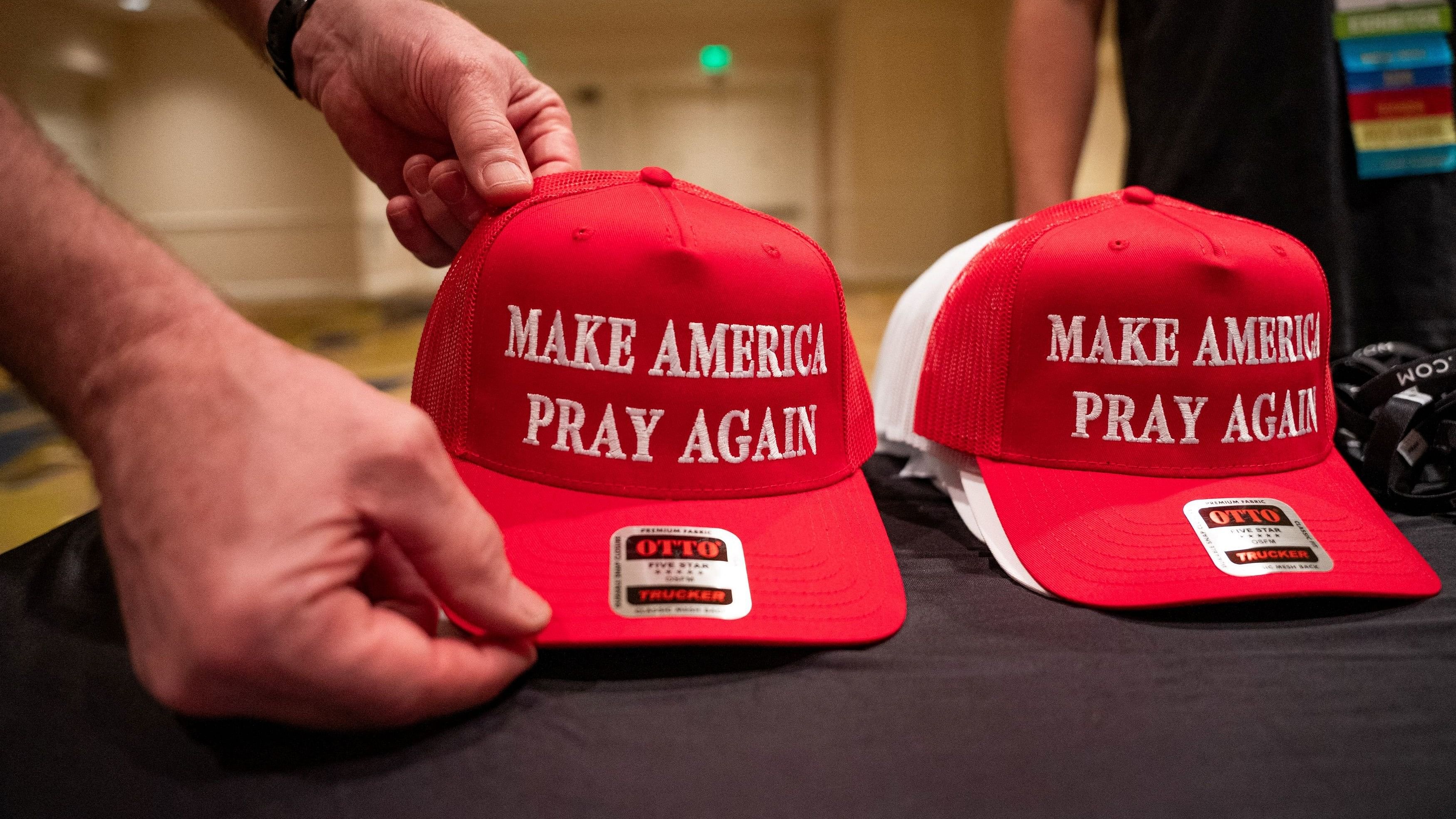 <div class="paragraphs"><p>Hats with the slogan 'Make America Pray Again' are displayed at the 2024 National Religious Broadcasters Association International Christian Media Convention, earlier this year.</p></div>