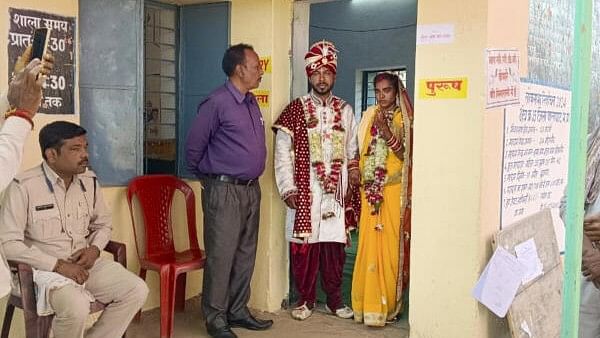 <div class="paragraphs"><p>A newly-wedded couple at a polling station after casting their votes for the first phase of Lok Sabha elections, in Balaghat district, Friday, April 19, 2024.</p></div>