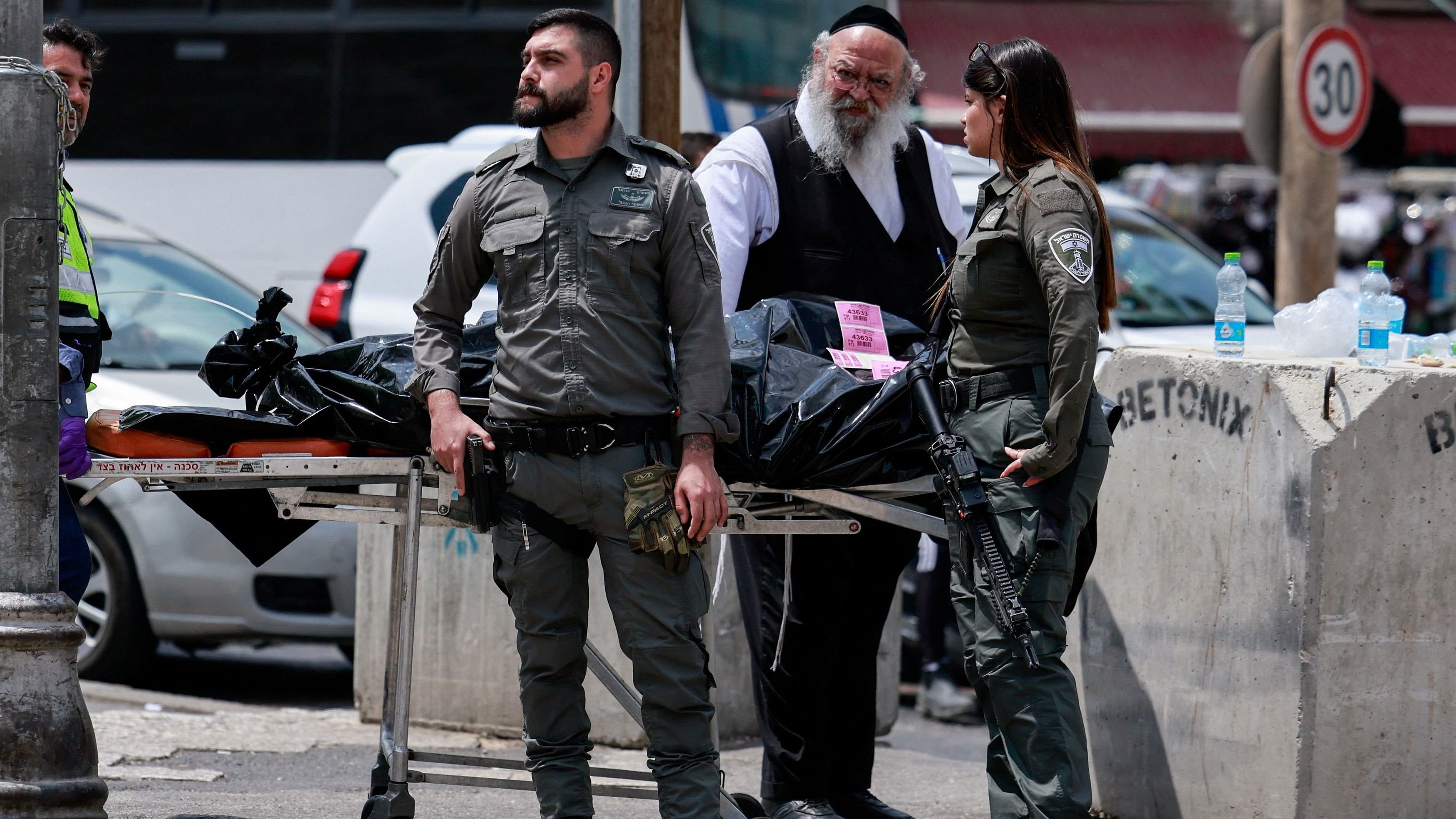 <div class="paragraphs"><p>Israeli emergency personnel and a man stand next to the body of an attacker who, according to the Israeli police, is a Turkish citizen, as Israeli emergency personnel respond to a stabbing attack, in Jerusalem April 30, 2024.</p></div>