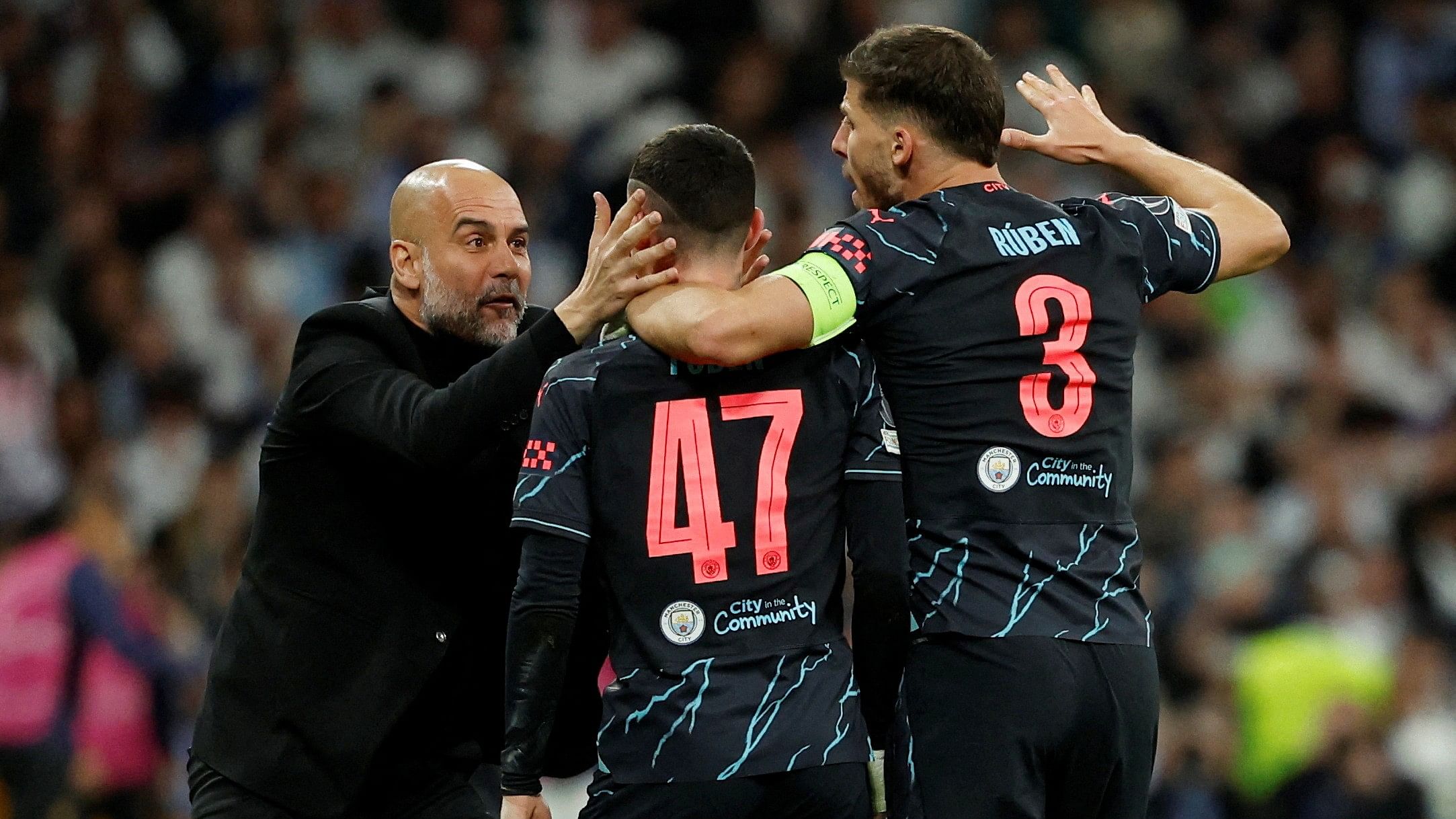 <div class="paragraphs"><p>Manchester City's Phil Foden celebrates scoring their second goal with manager Pep Guardiola and Ruben Dias</p></div>