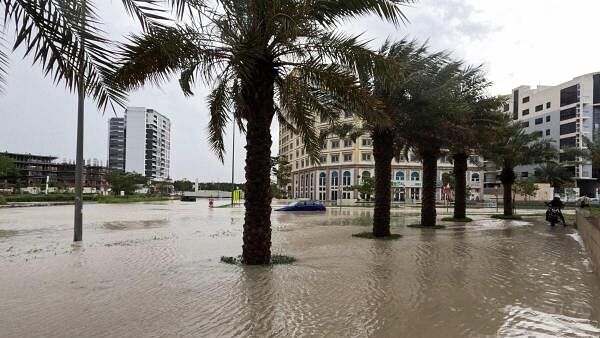 <div class="paragraphs"><p>A person rides a motorcycle near a flooded street during a rain storm in Dubai, United Arab Emirates.</p></div>