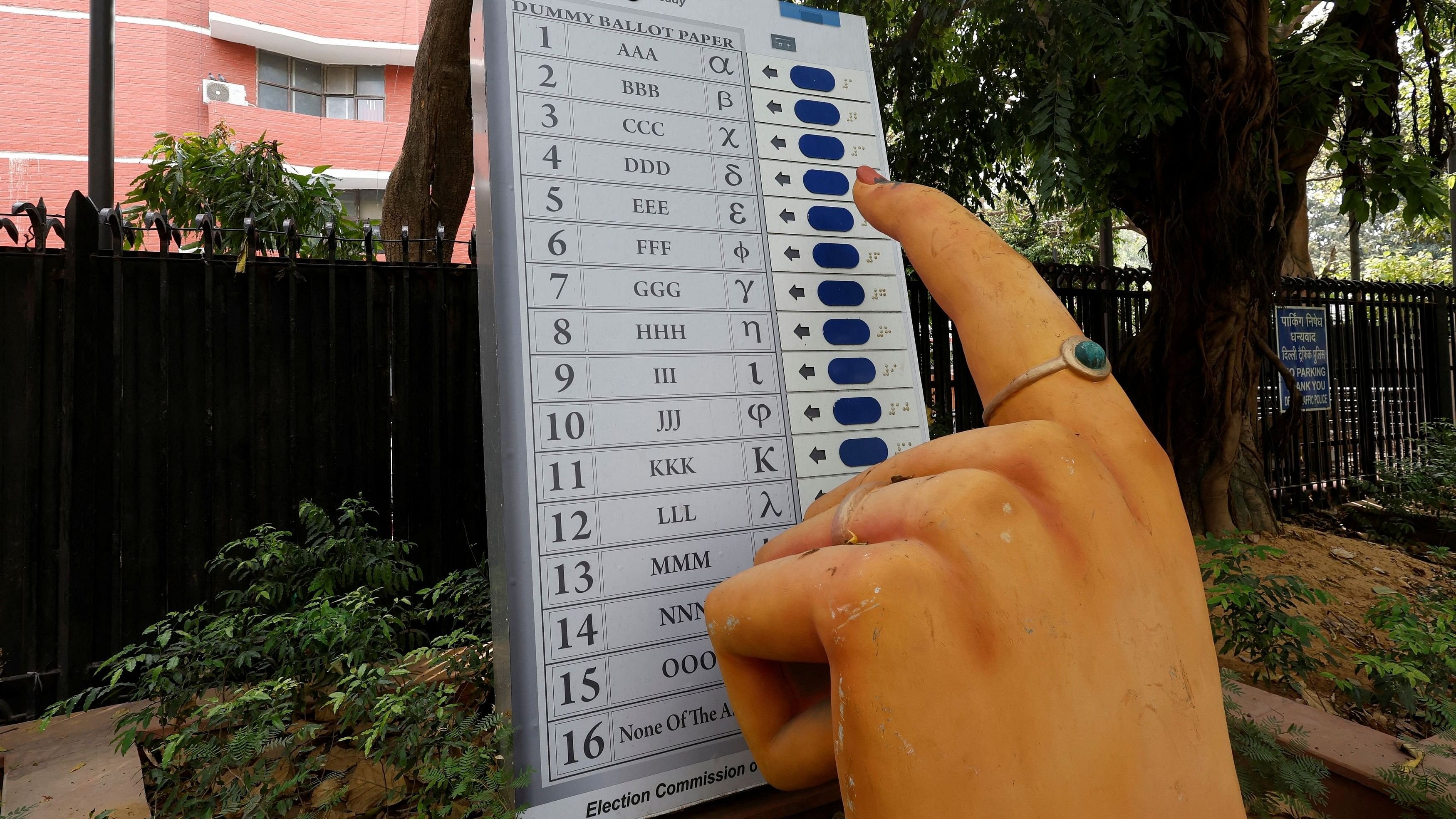 <div class="paragraphs"><p>A model of Electronic Voting Machine  is displayed outside the office of the Election Commission of India, ahead of the country's general election, in New Delhi, April 15, 2024. </p></div>