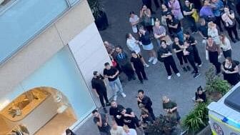 <div class="paragraphs"><p>People stand near the Westfield Bondi Junction shopping center, as they witness an incident, in which an attacker was shot after fatally wounding several people with a knife, in Sydney.</p></div>