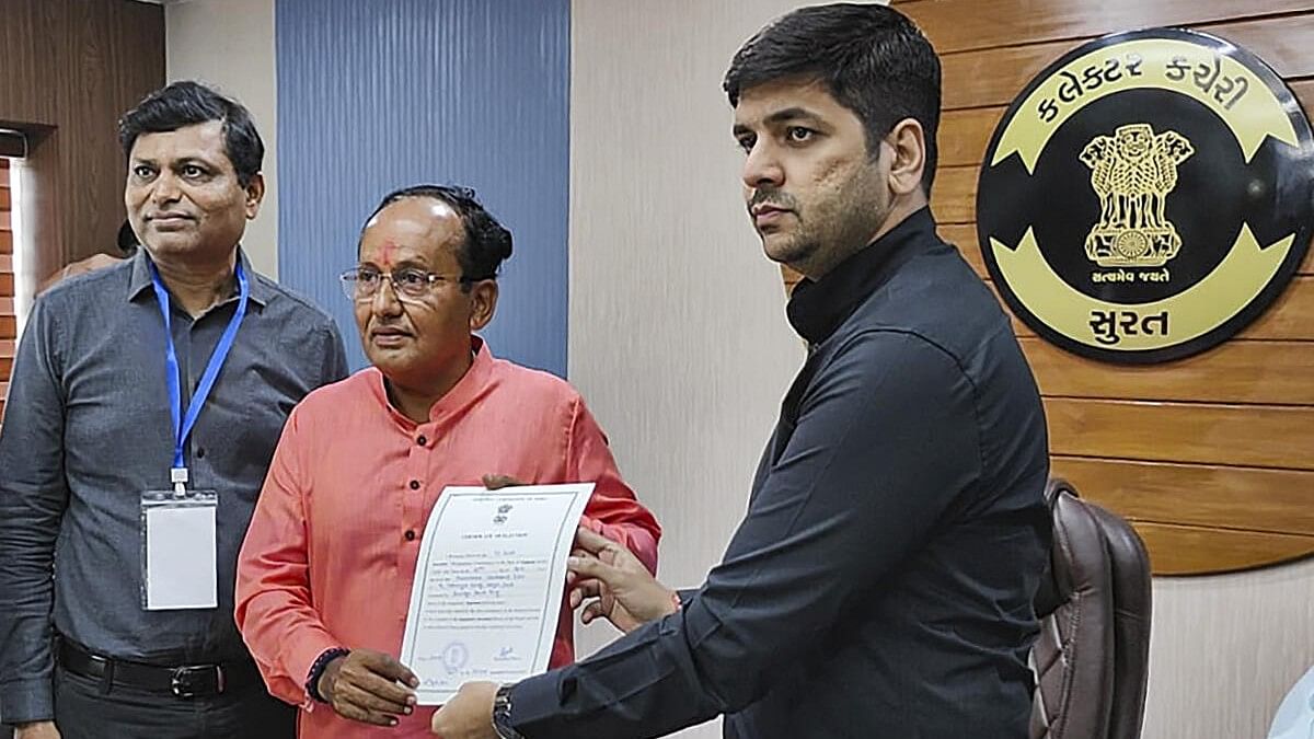 <div class="paragraphs"><p>BJP leader Mukesh Dalal receives the 'certificate of election' after he was elected unopposed from Surat Lok Sabha seat.</p></div>