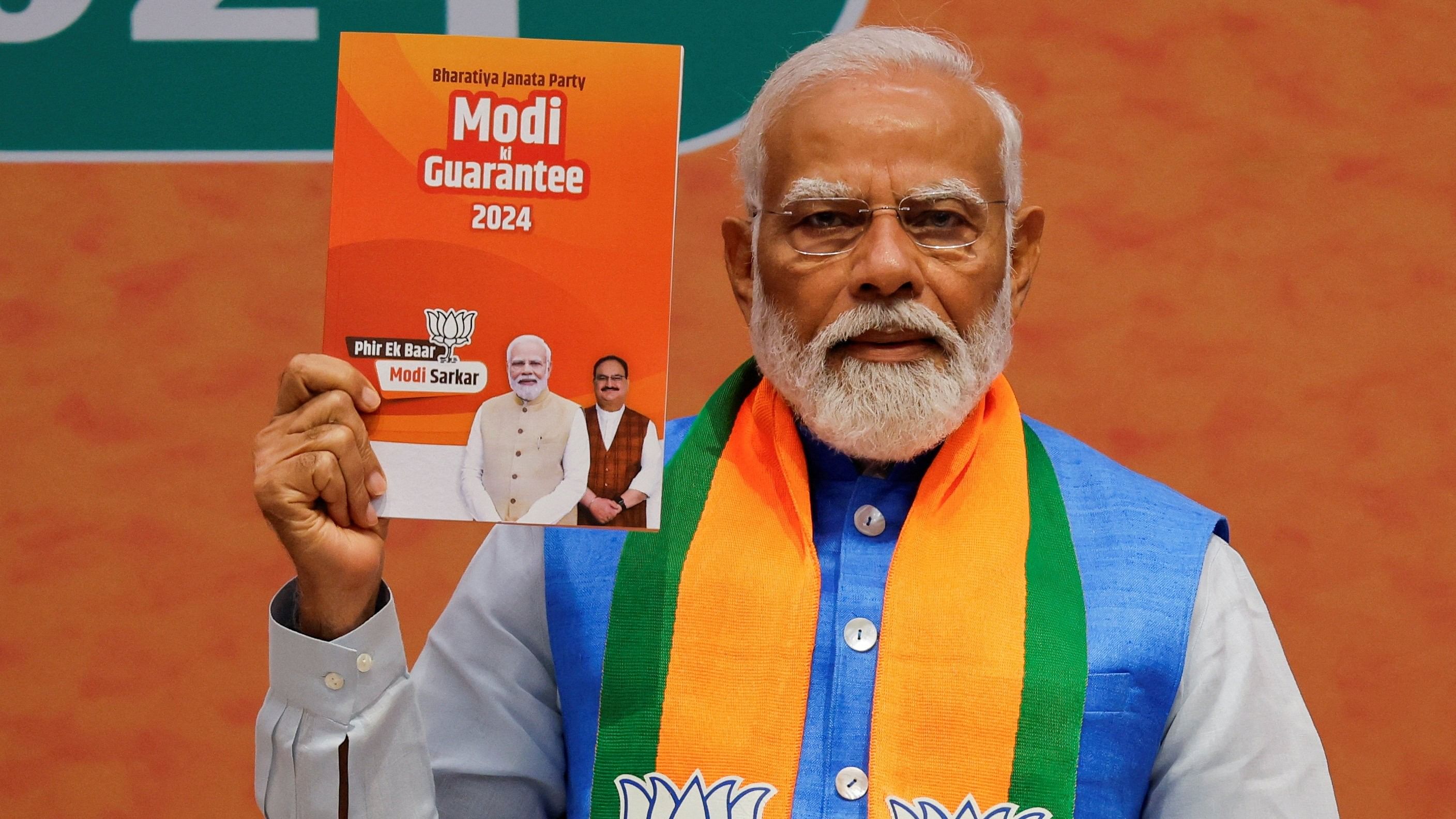 <div class="paragraphs"><p>Prime Minister Narendra Modi displays a copy of the Bharatiya Janata Party's  election manifesto for the general election.</p></div>