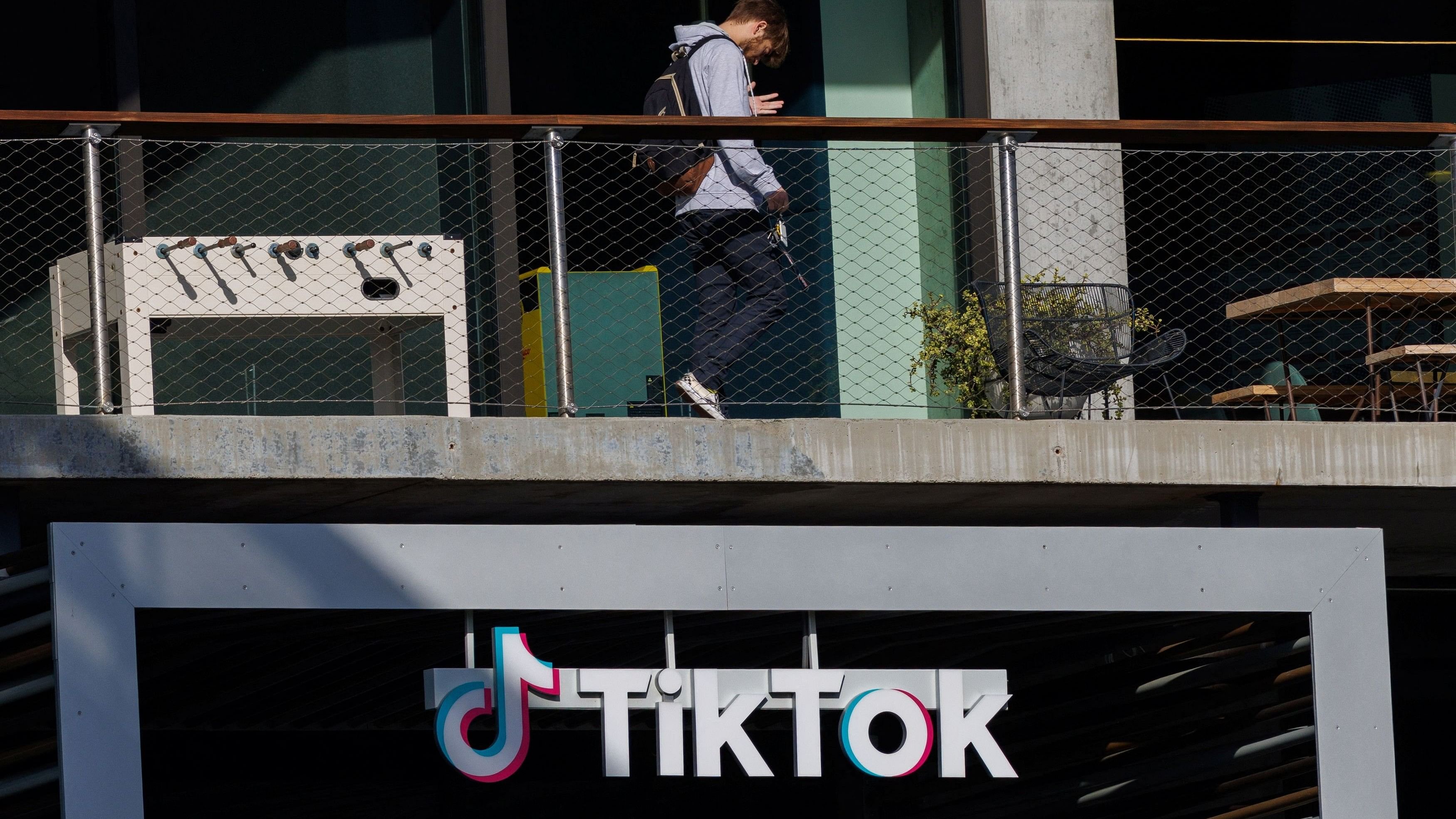 <div class="paragraphs"><p>A person arrives at the offices of Tik Tok after the US House of Representatives overwhelmingly passed a bill that would give TikTok's Chinese owner ByteDance about six months to divest the US assets of the short-video app or face a ban.</p></div>