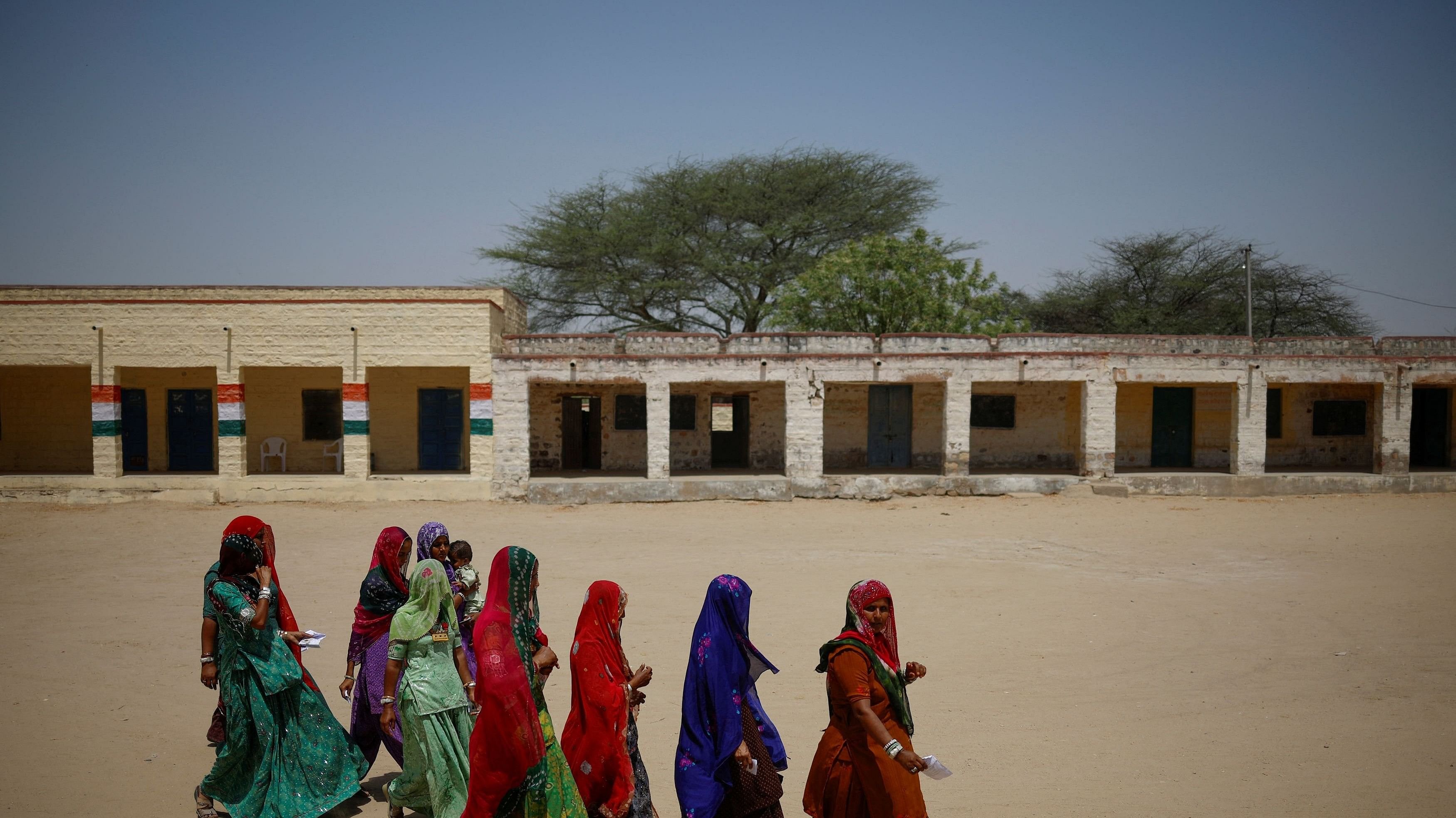 <div class="paragraphs"><p>Women arrive at a polling station to cast their vote during the second phase of the general elections, in Barmer, Rajasthan, India.</p></div>