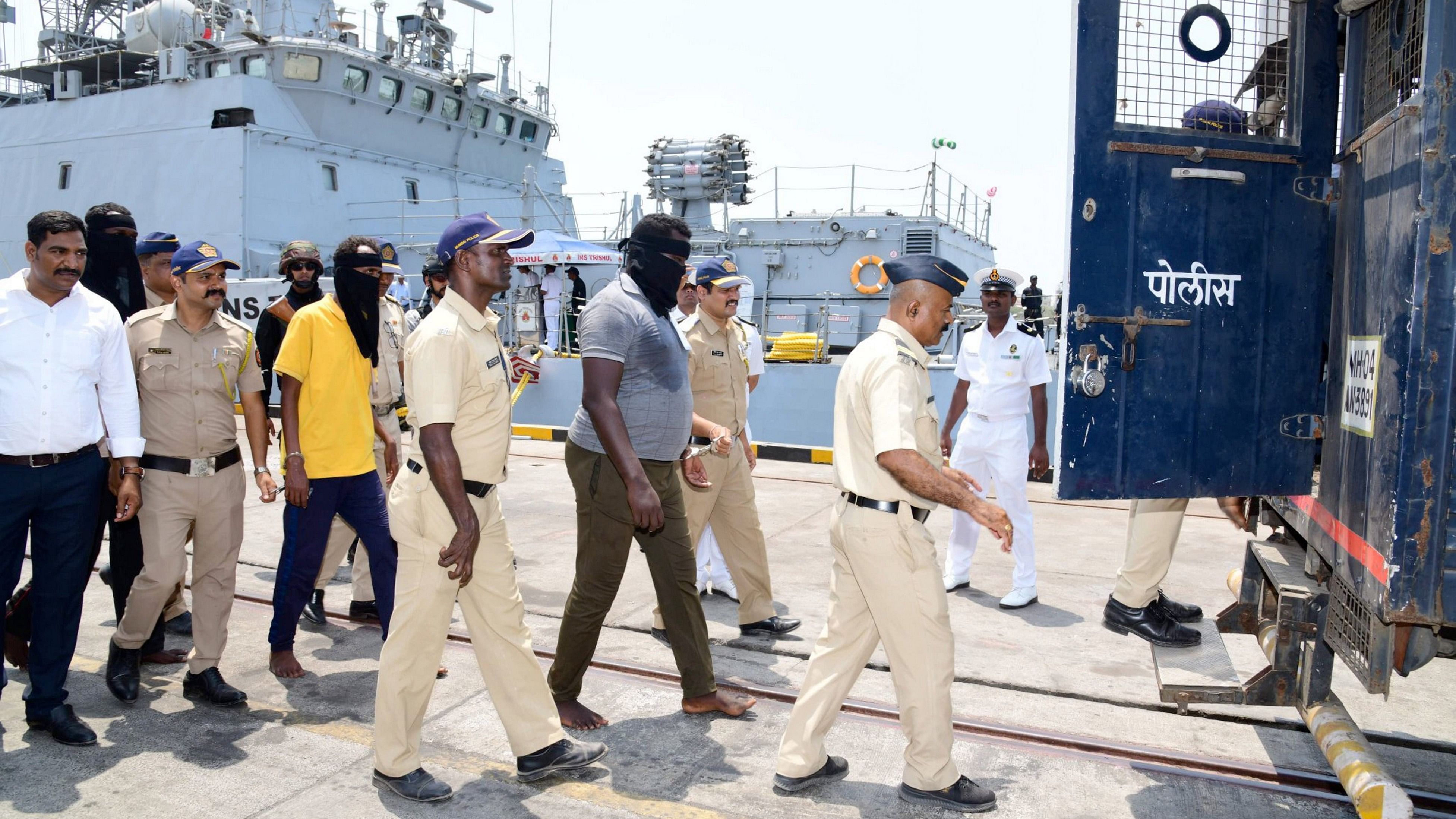 <div class="paragraphs"><p>Police take away nine pirates who were handed over by the Indian Navy in Mumbai.   </p></div>