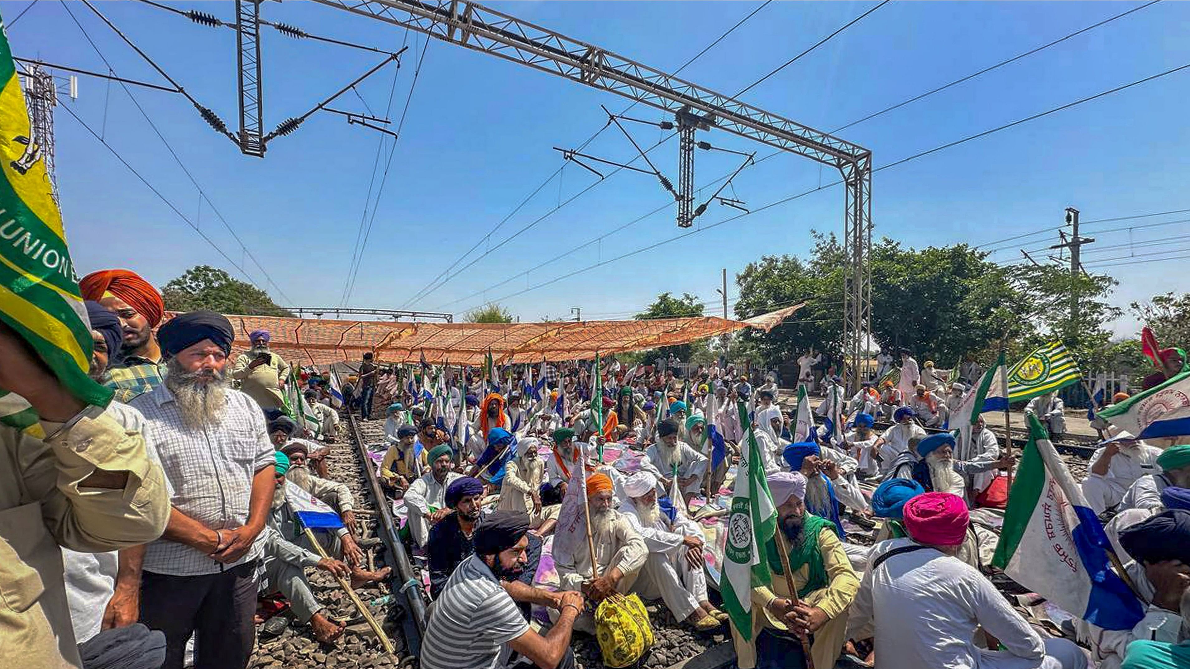 <div class="paragraphs"><p>Farmers sit on railway tracks during a protest at the Shambhu border, in Patiala district.</p></div>