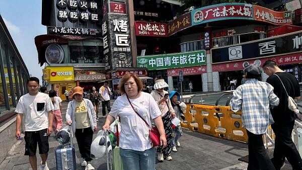 <div class="paragraphs"><p>People walk at a restaurant complex in China.</p></div>