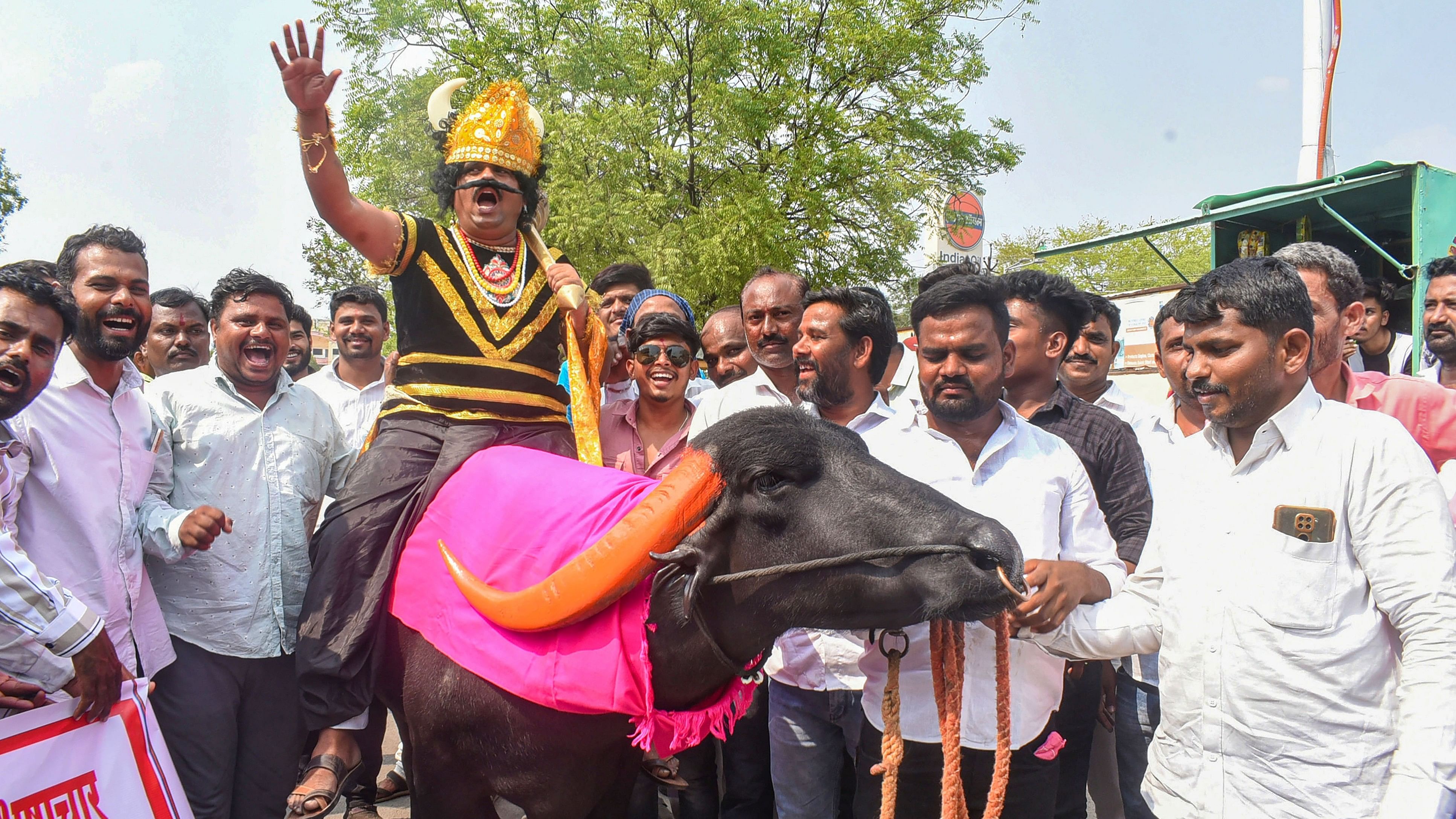 <div class="paragraphs"><p>Independent candidate from Madha constituency Ram Gaikwad rides a buffalo while being dressed as Lord Yama during a procession before filing nomination for the Lok Sabha elections, in Solapur district, Thursday, April 18, 2024. </p></div>