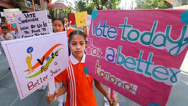 <div class="paragraphs"><p>School students and teachers participate in a voting awareness program in Jammu.</p></div>