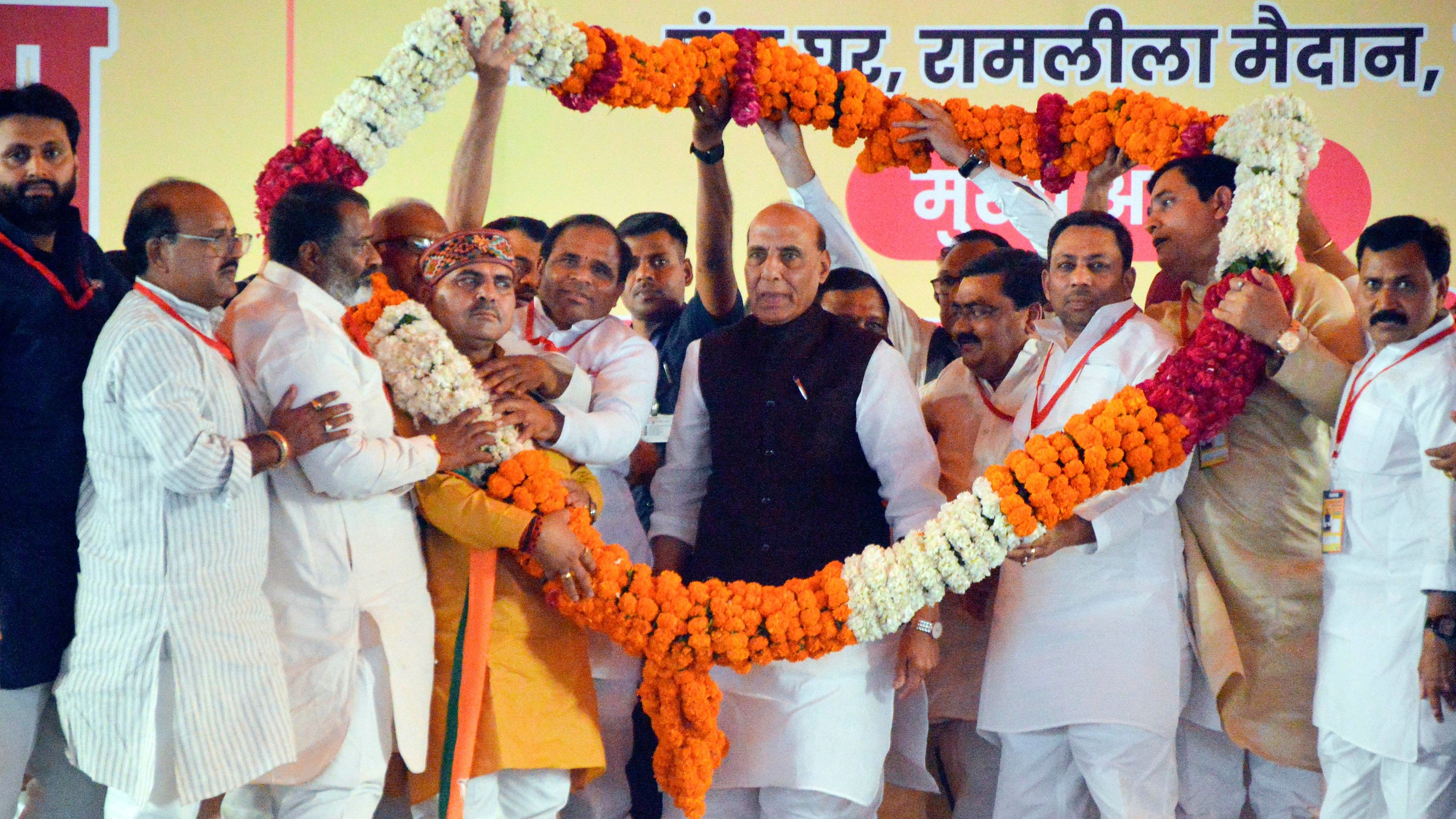 <div class="paragraphs"><p>Defence Minister Rajnath Singh being garlanded by BJP workers during a public meeting in support of BJP candidate Atul Garg ahead of upcoming Lok Sabha elections, in Ghaziabad, Wednesday, April 3, 2024. </p></div>