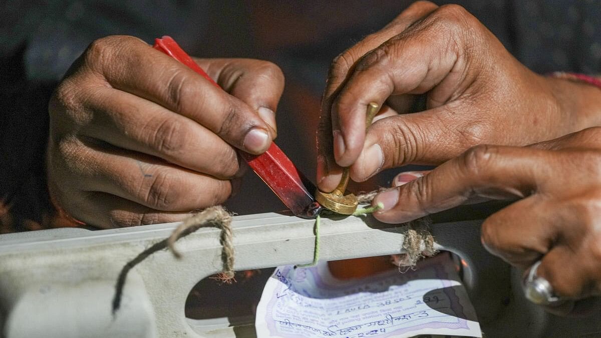 <div class="paragraphs"><p>Election officials seal an Electronic Voting Machine after the voting concluded for the second phase of Lok Sabha elections at Masuri in Ghaziabad district.</p></div>