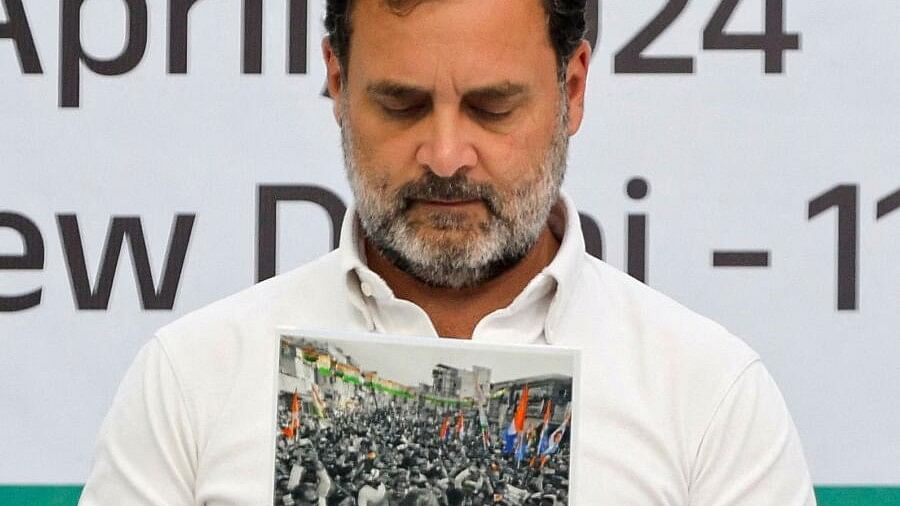 <div class="paragraphs"><p>Rahul Gandhi looks at the party's manifesto for the general election, in New Delhi, India, April 5, 2024.</p></div>