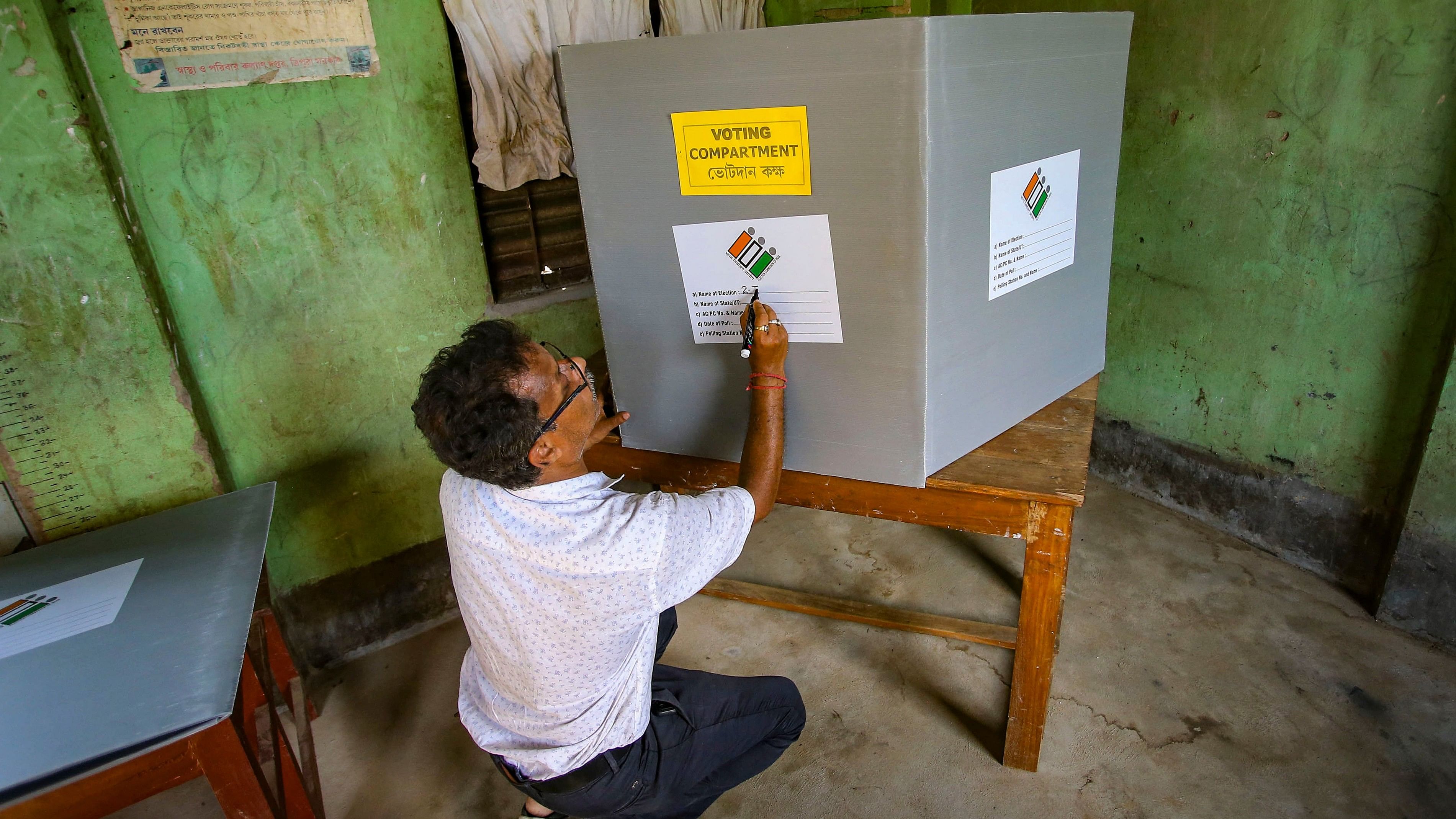 <div class="paragraphs"><p>A polling official prepares a booth for the second phase of Lok Sabha elections, at Kanchanpur in North Tripura disrict</p></div>