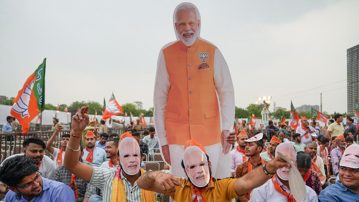 <div class="paragraphs"><p>BJP supporters wear masks of Prime Minister Narendra Modi.</p></div>