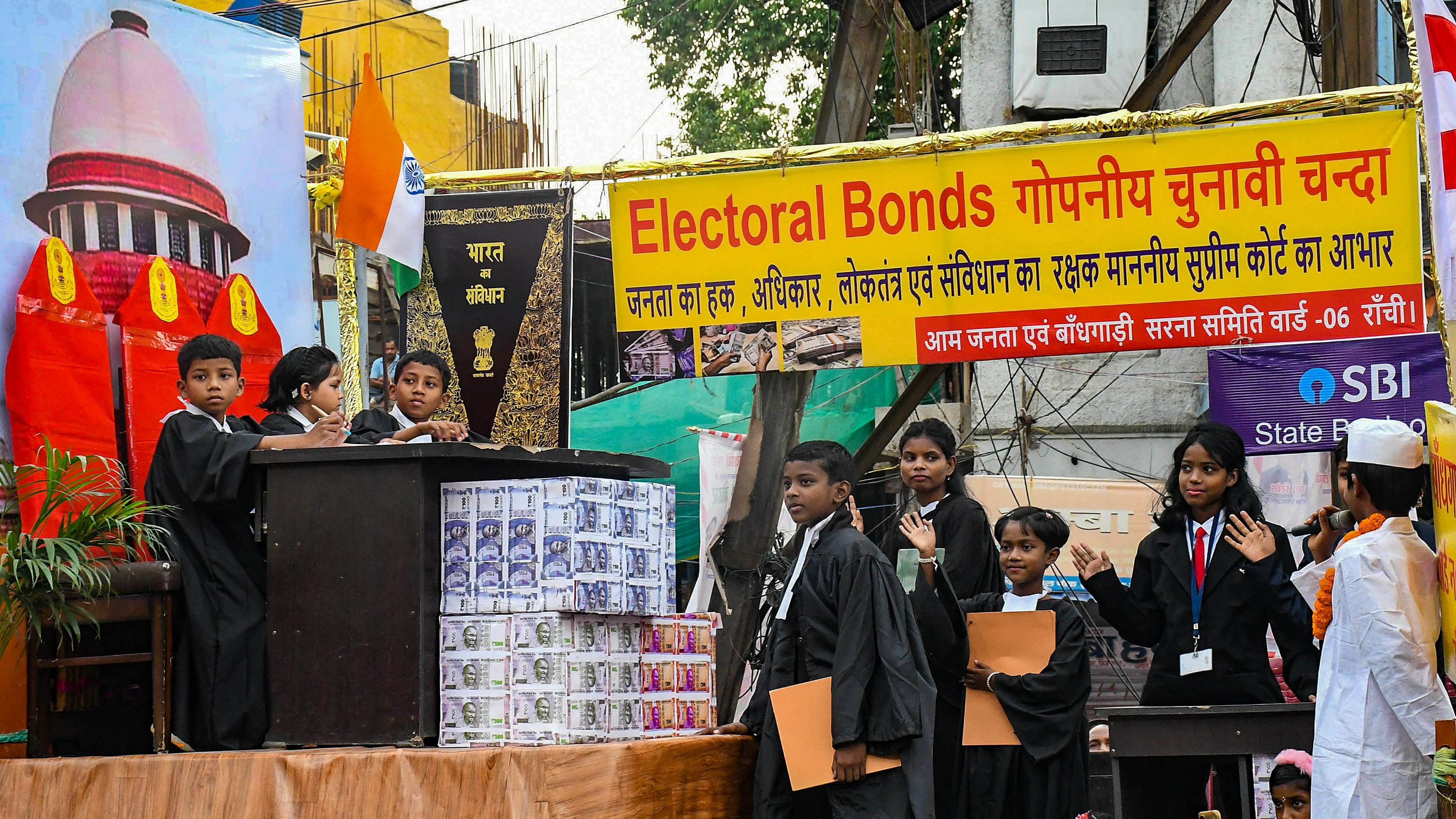 <div class="paragraphs"><p>School children enact a play on the theme of electoral bond as they participate in Sarhul procession, in Ranchi. Image for representation only.</p></div>