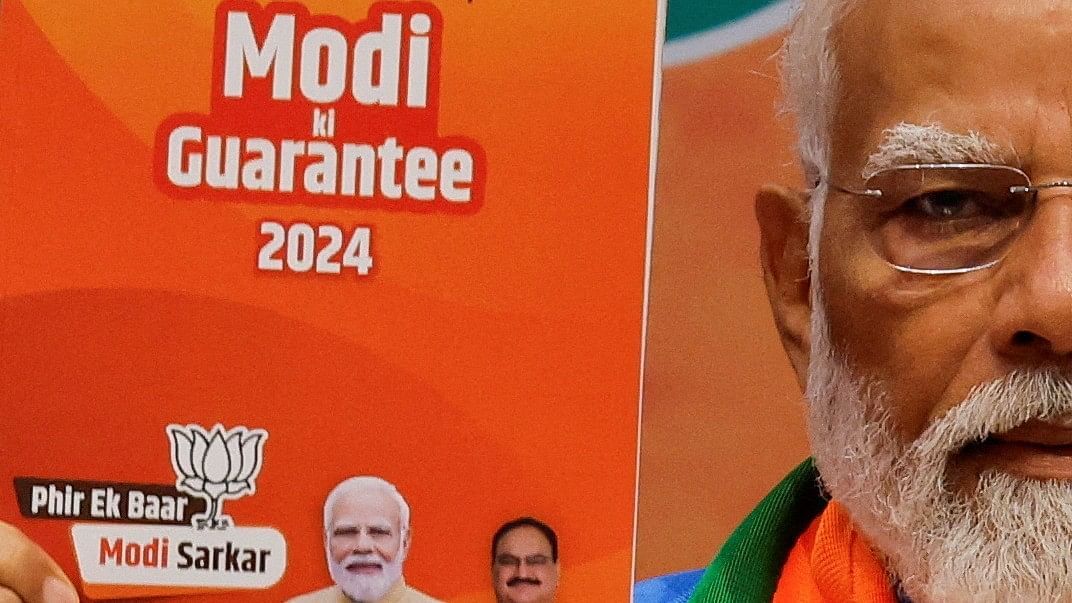 <div class="paragraphs"><p>Prime Minister Narendra Modi displays a copy of the BJP election manifesto for the general election, in New Delhi, on April 14, 2024.</p></div>