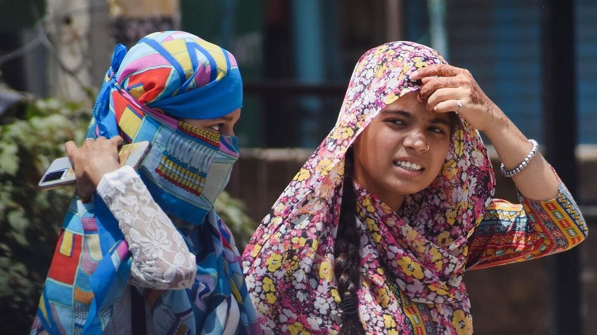 <div class="paragraphs"><p>A photo of commuters using scarves to shield themselves from the heat on a hot summer day. Representative image.</p></div>