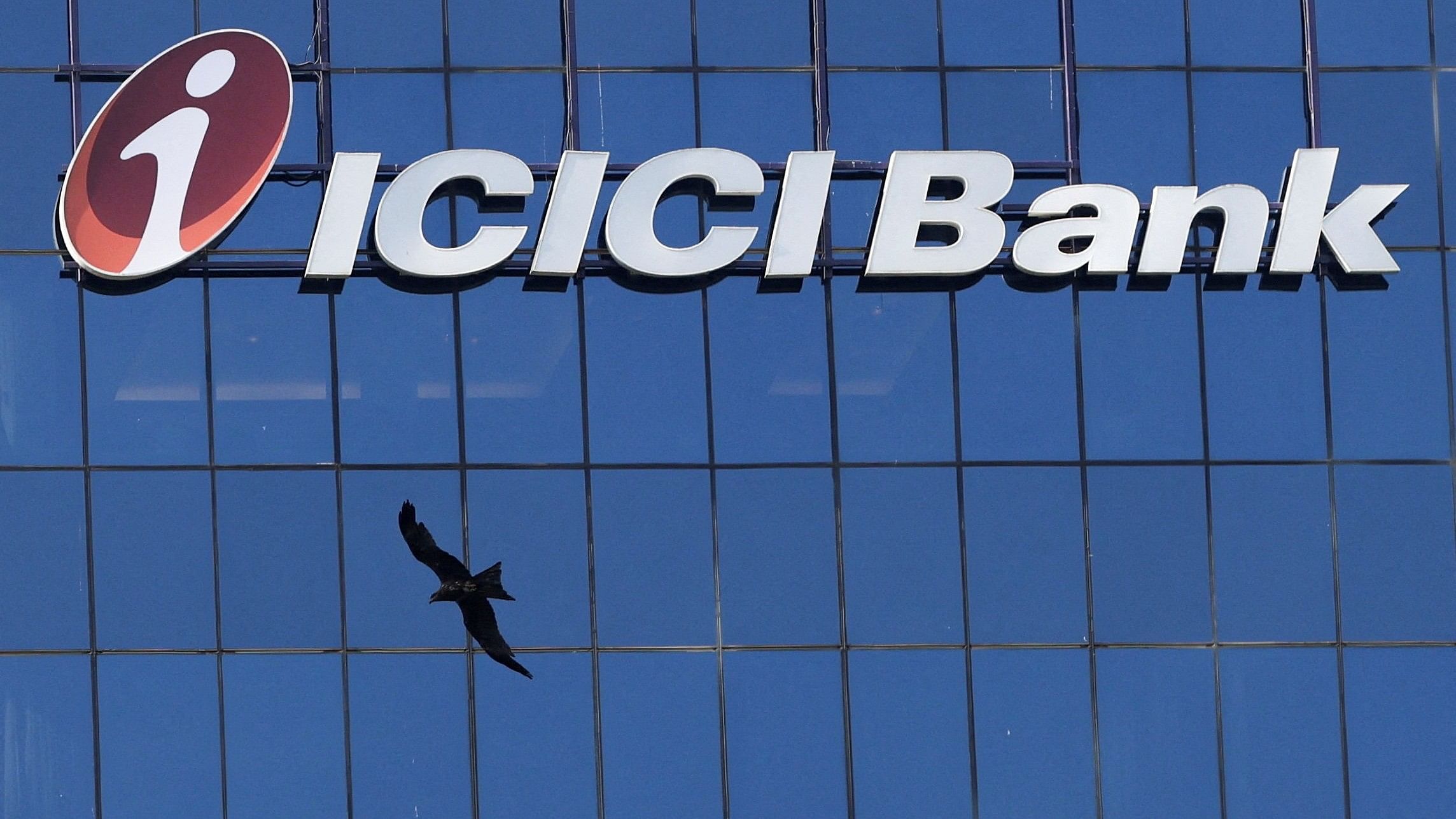 <div class="paragraphs"><p>A bird flies past the facade of the ICICI bank head office in Mumbai, India.</p></div>