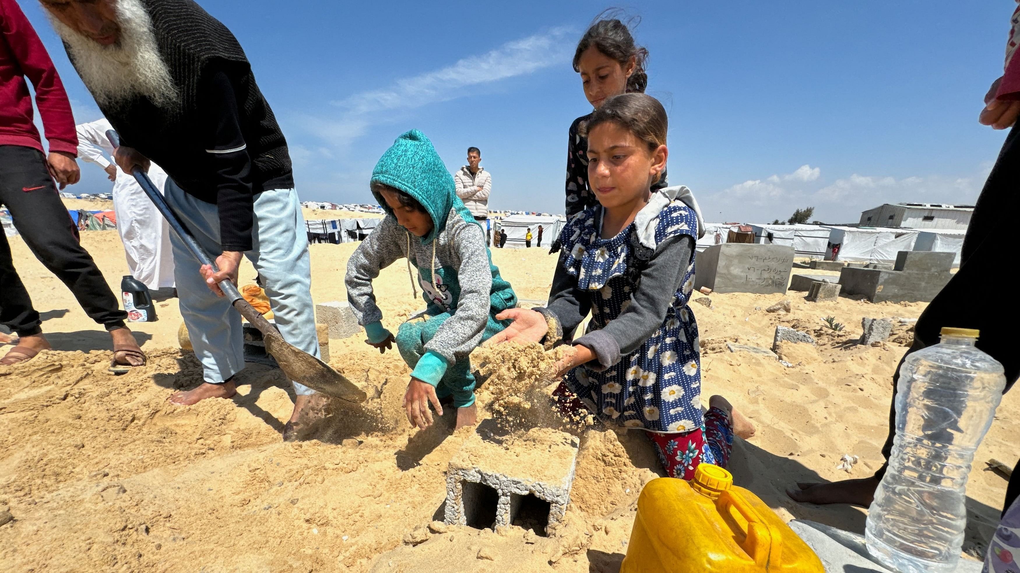 <div class="paragraphs"><p>People bury the body of displaced Christian Palestinian Hany Dawood, who died of a kidney disease, at a Muslim graveyard, as his family was not able to receive his body and bury him at the Christian cemetery in Gaza City due to Israeli measures that ban the movement from the south of the Gaza Strip to its north,  April 7, 2024. </p></div>