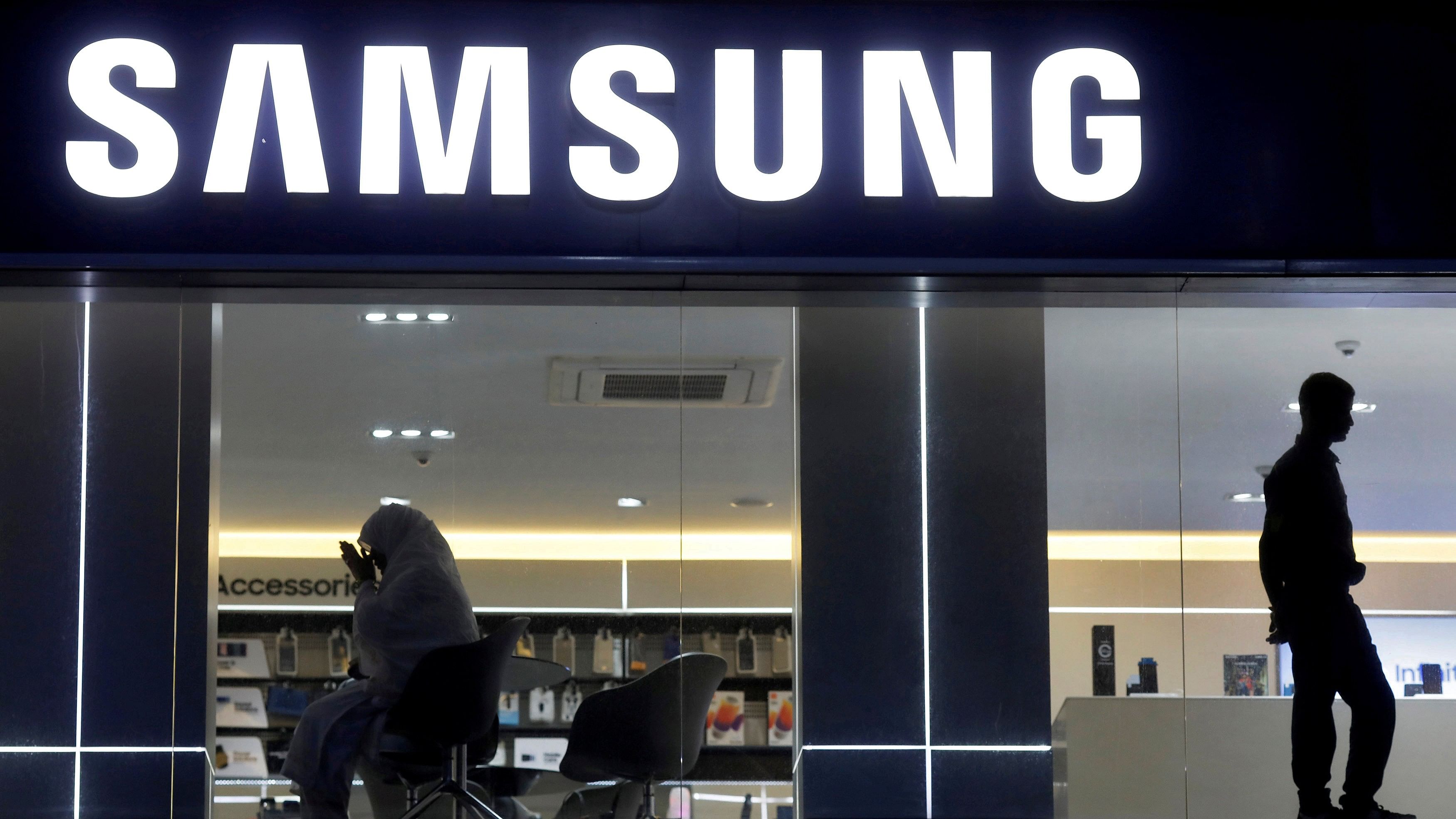 <div class="paragraphs"><p>A customer prays inside a Samsung showroom in New Delhi</p></div>