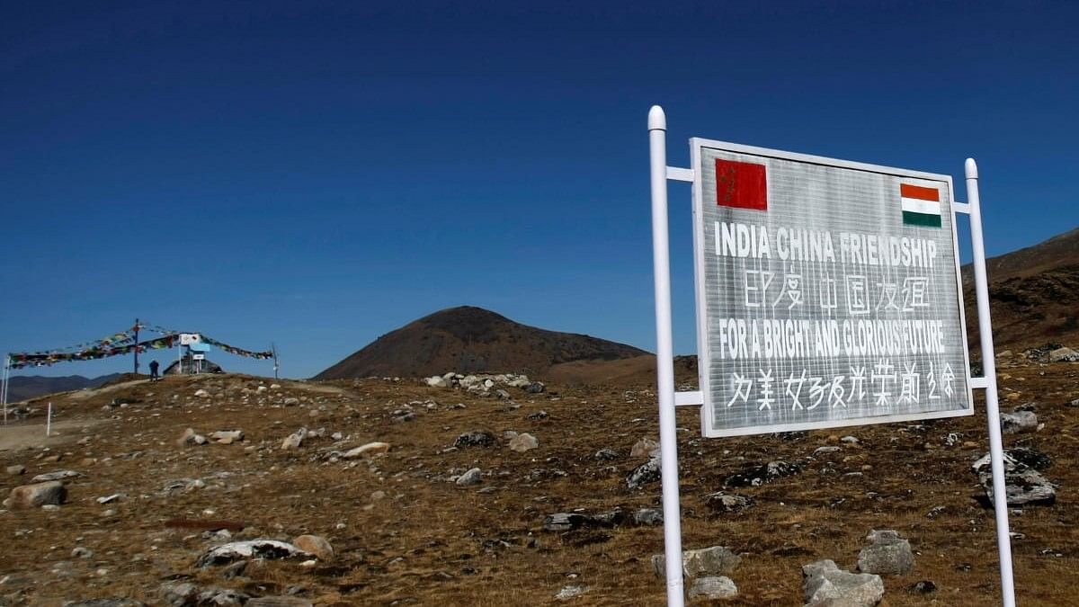 <div class="paragraphs"><p>A signboard is seen from the Indian side of the Indo-China border at Bumla</p><p></p></div>