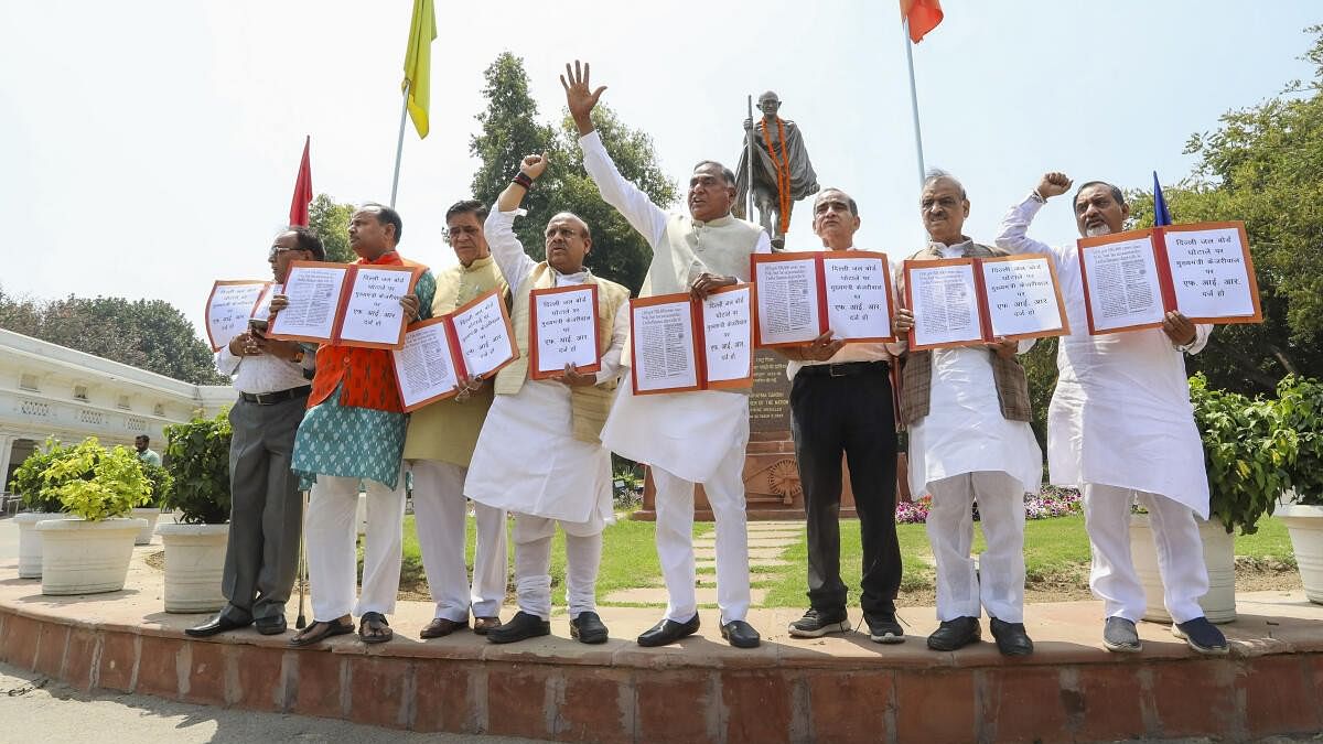 <div class="paragraphs"><p>BJP MLA Ramvir Singh Bidhuri with party MLAs raises slogans during a protest outside the Delhi Legislative Assembly, in New Delhi.</p></div>