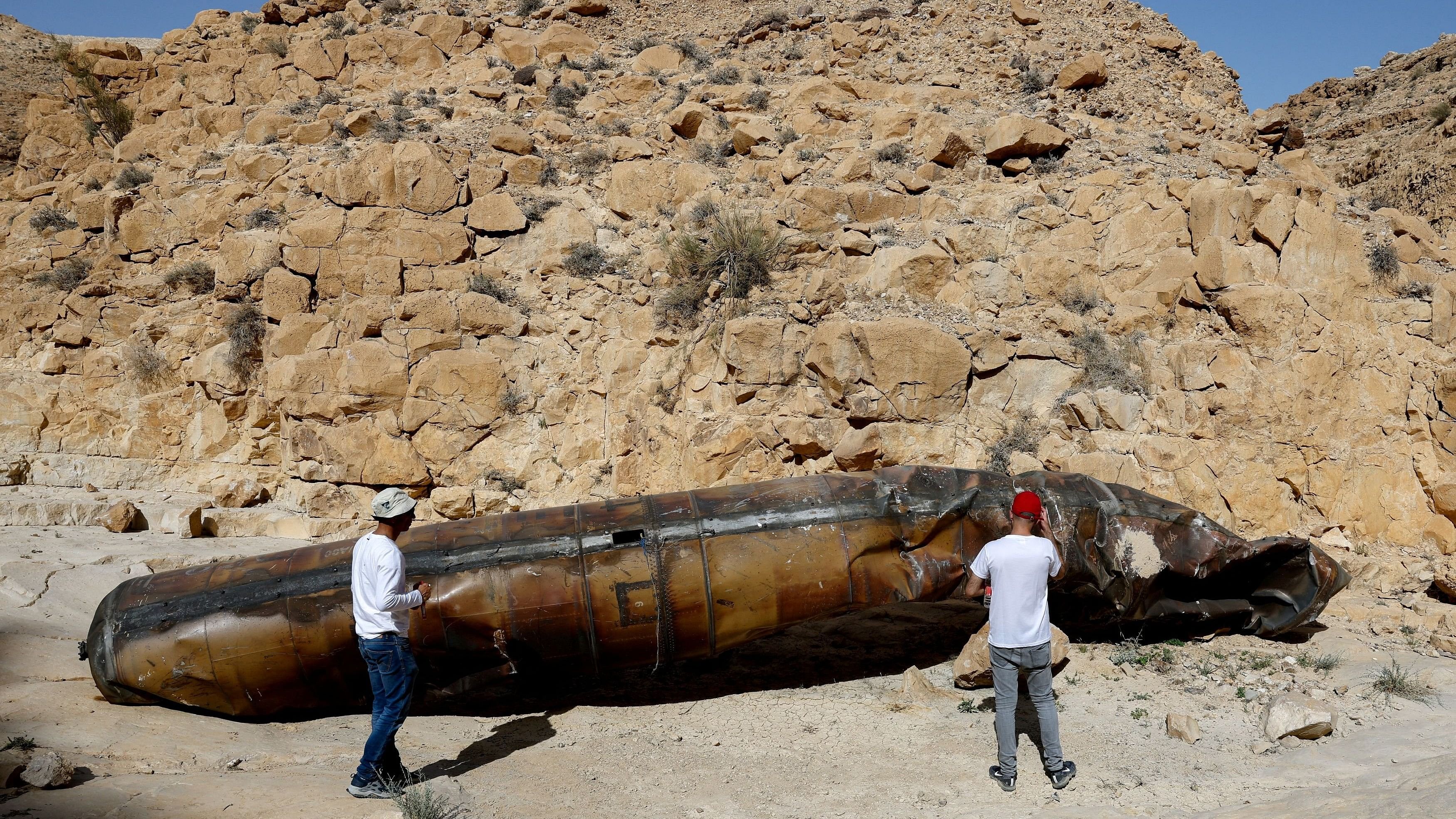 <div class="paragraphs"><p>Members of military personnel in civilian clothing inspect apparent remains of a ballistic missile lying in the desert, following a massive missile and drone attack by Iran on Israel, near the southern city of Arad, Israel April 24, 2024.</p></div>