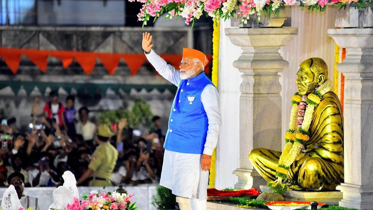 <div class="paragraphs"><p>Prime Minister Narendra Modi waves at supporters before a road show ahead of Lok Sabha polls, in Mangaluru.&nbsp;</p></div>