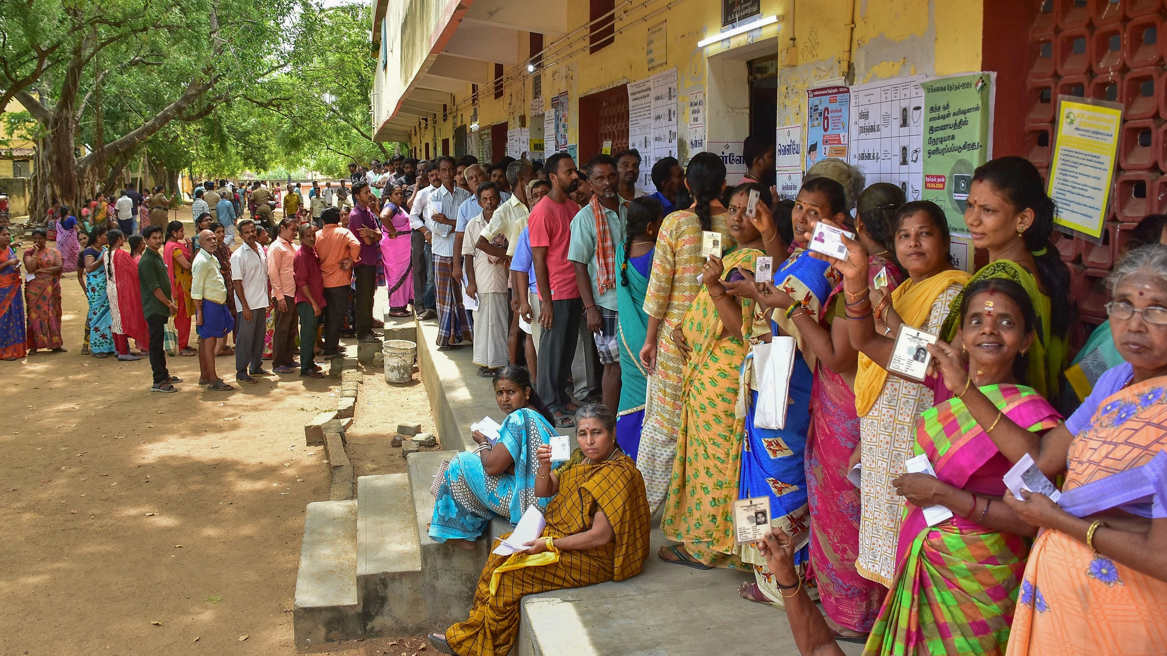 <div class="paragraphs"><p>People wait to cast their votes for the Lok Sabha elections, in Madurai, Friday, April 19, 2024.</p></div>