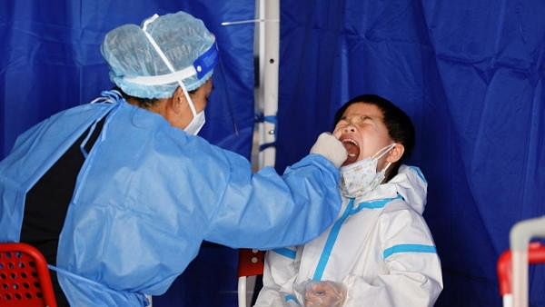 <div class="paragraphs"><p>A child wearing personal protective equipment (PPE) has his swab sample taken for nucleic acid test, amid the coronavirus  pandemic, in Hong Kong, China.</p></div>