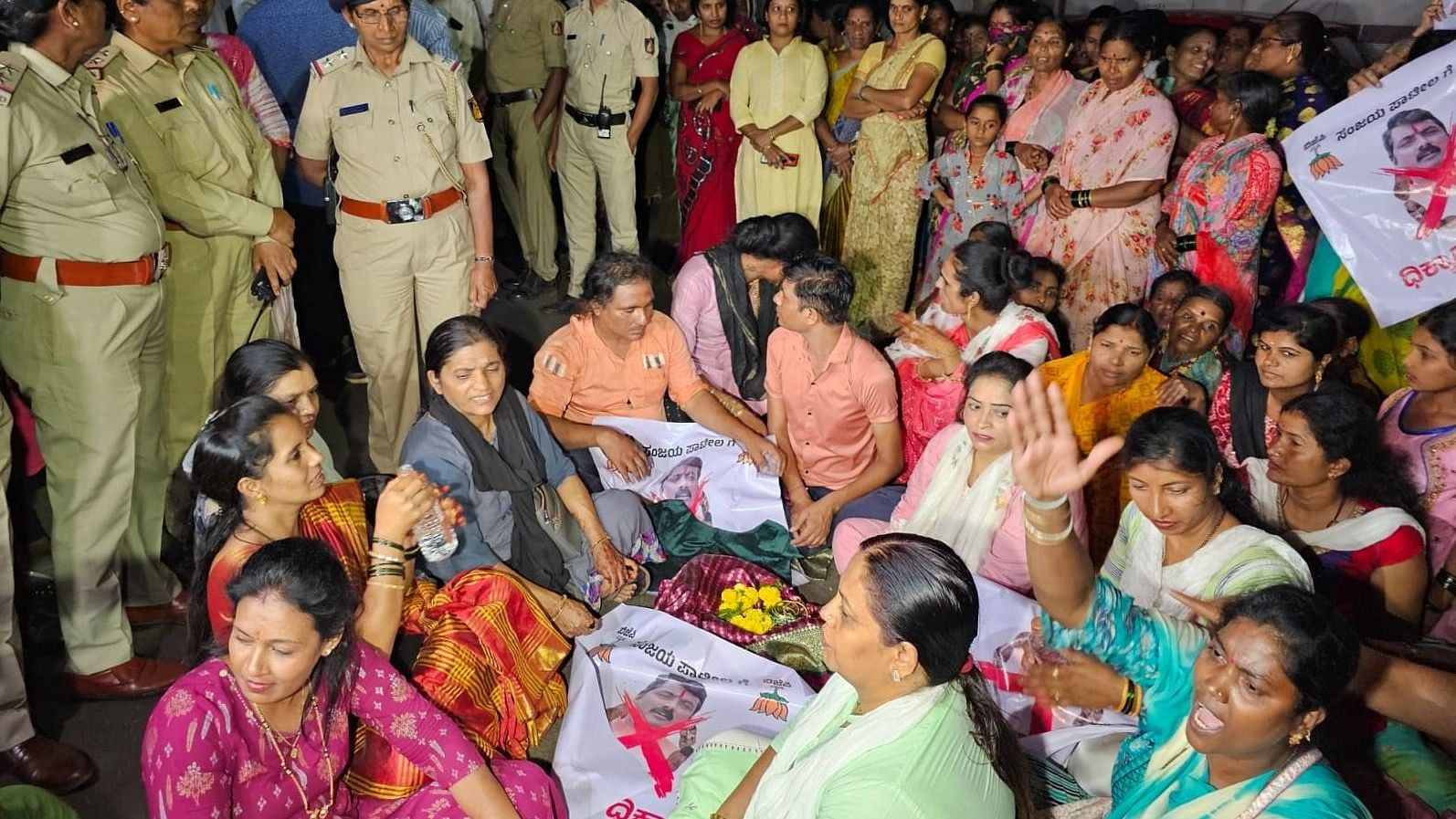 <div class="paragraphs"><p>Women workers of the Congress stage a protest in front of the&nbsp;residence of former BJP MLA Sanjay Patil in Belagavi on Saturday night. </p></div>