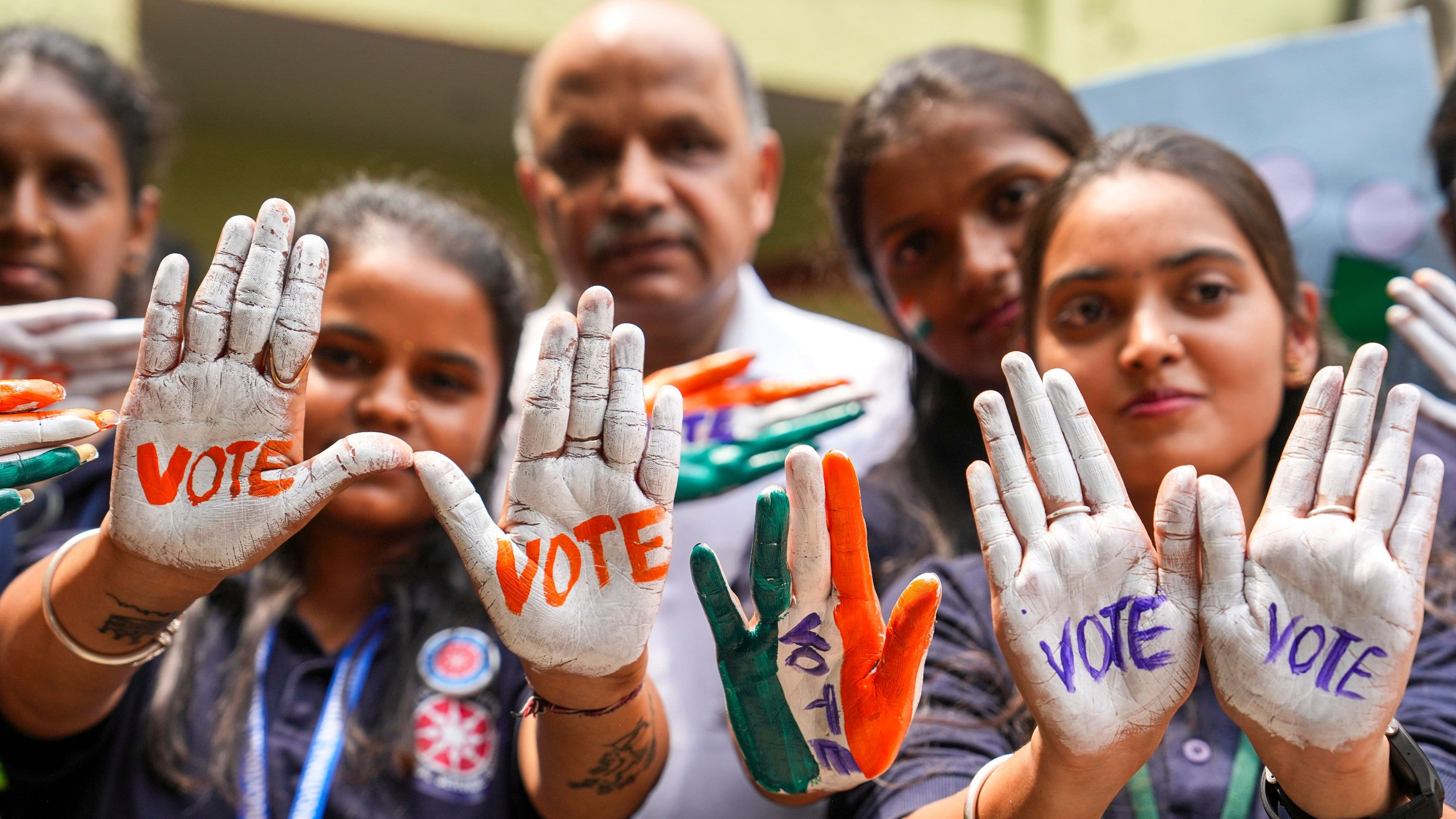 <div class="paragraphs"><p>Students with their hands painted urging to vote for ongoing Lok Sabha polls take part in a voter awareness campaign, in Bengaluru, Saturday, April 20, 2024. </p></div>
