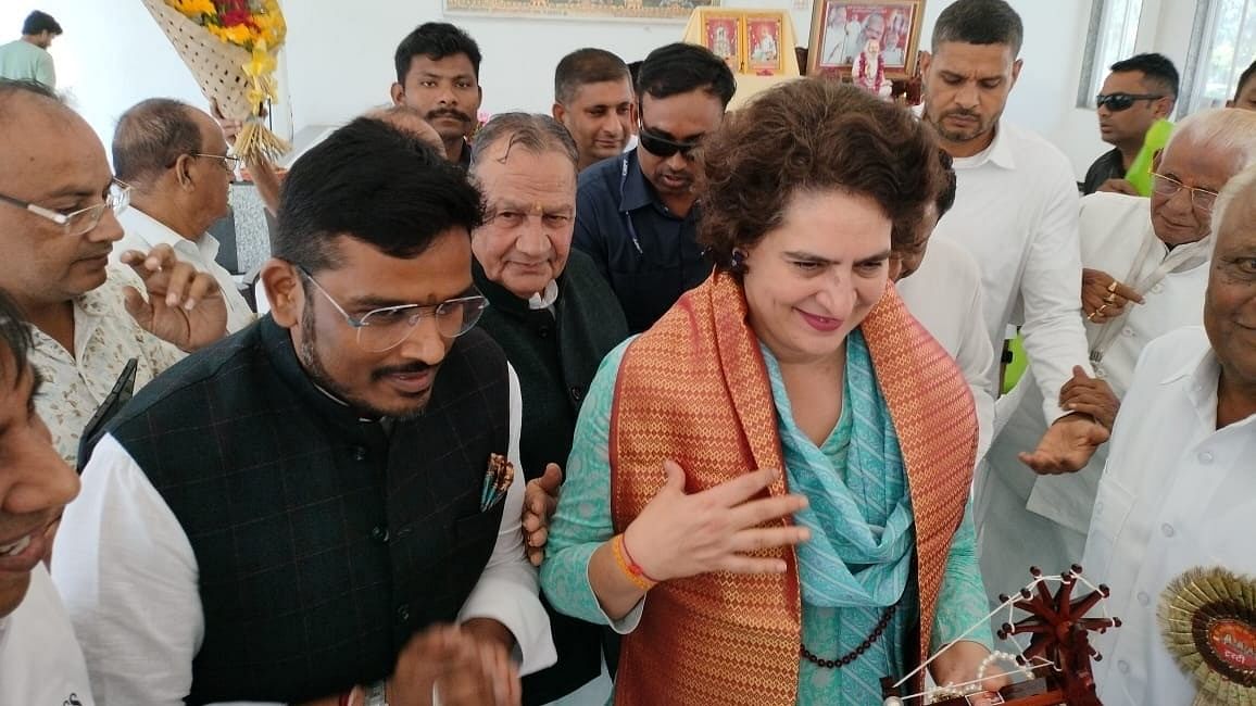 <div class="paragraphs"><p>Akshay Kanti Bam with Congress leader Priyanka Gandhi Vadra.<br></p></div>