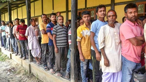 <div class="paragraphs"><p>People wait to cast their votes for the second phase of Lok Sabha elections, at Mayong in Morigaon district, Friday, April 26, 2024</p></div>