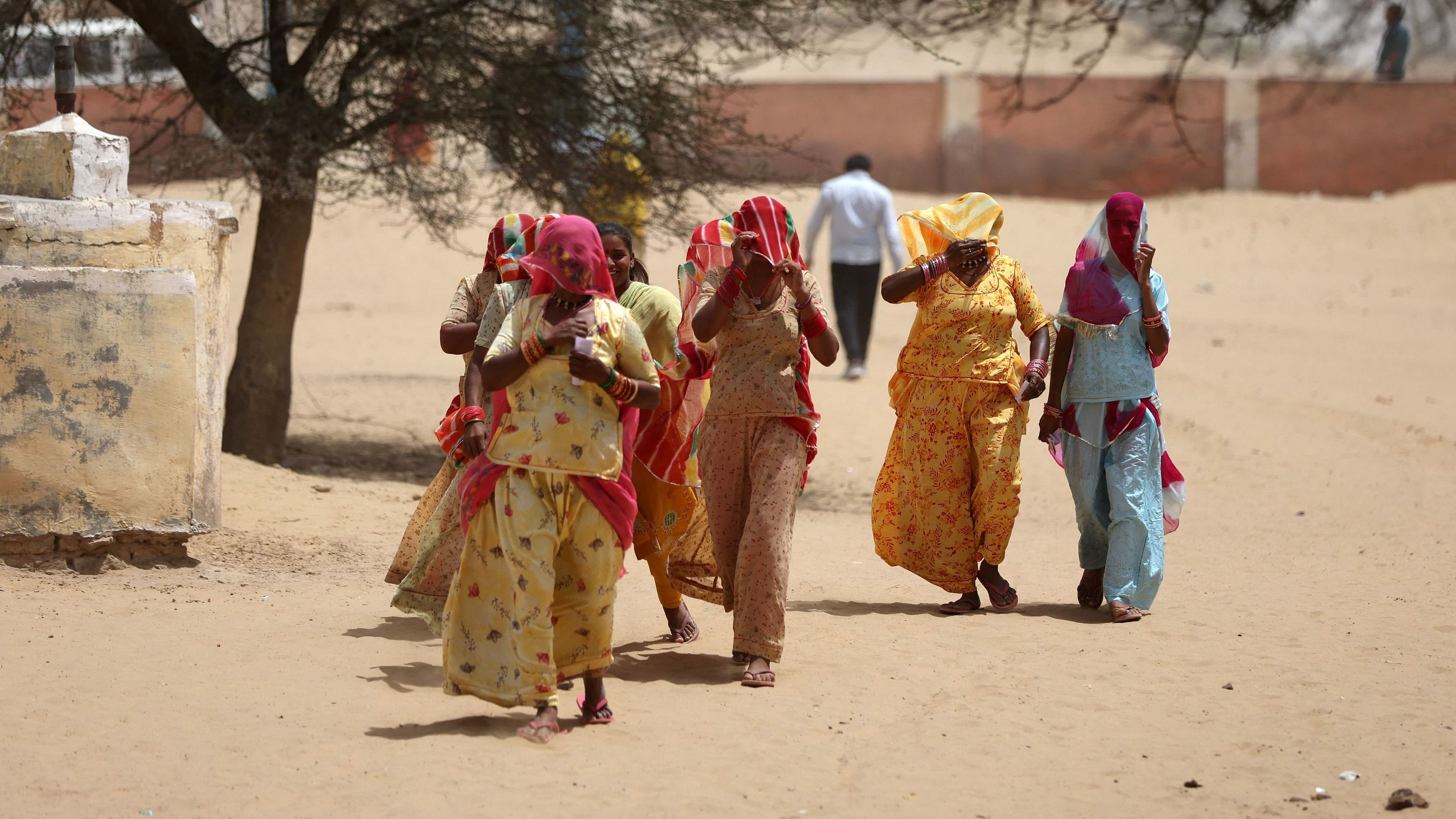 <div class="paragraphs"><p>File Photo: Women cover their faces to protect from heat as they arrive at a polling station to cast their votes during the first phase of the general election, in Bikaner district, Rajasthan, April 19, 2024. </p></div>