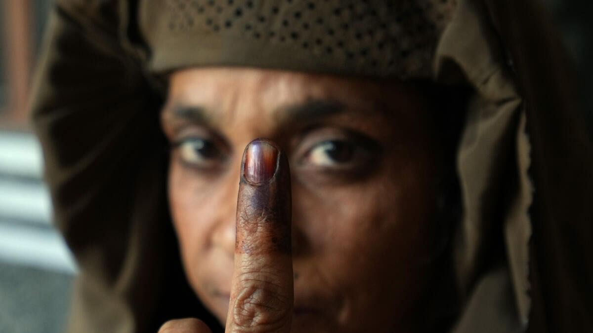 <div class="paragraphs"><p>A Muslim woman shows her finger marked with indelible ink after casting her vote for the first phase of Lok Sabha elections, at a polling station in Kairana, Friday, April 19, 2024.</p></div>